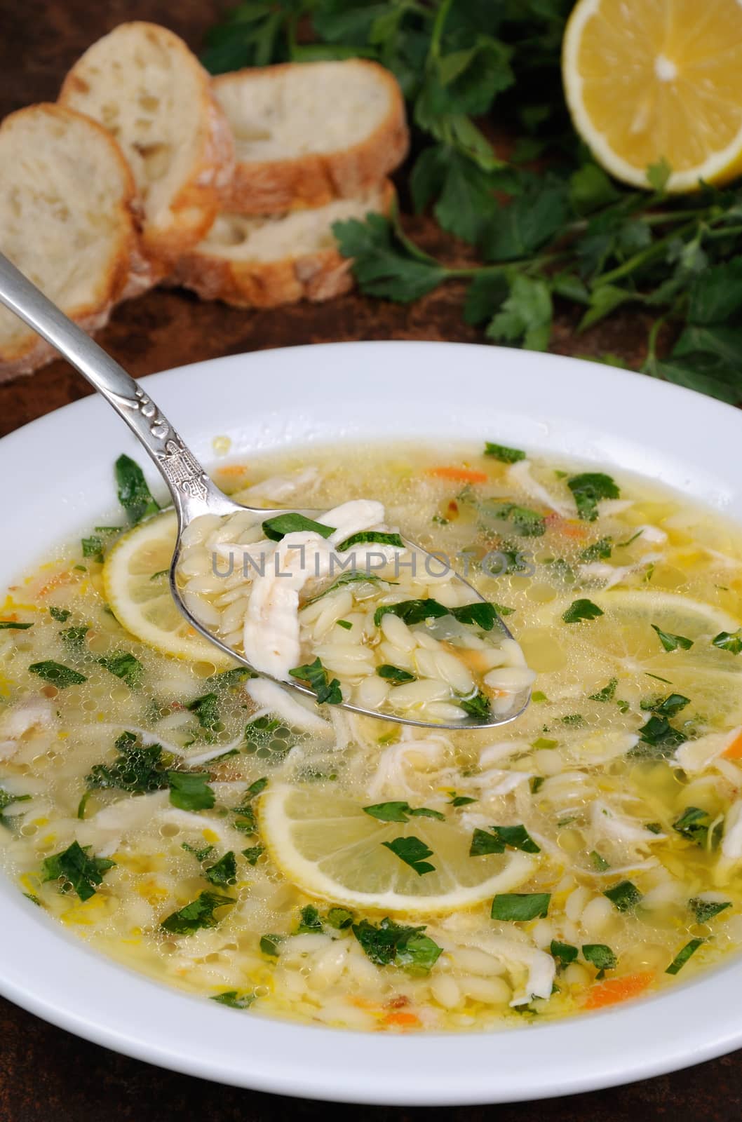 Avgolemono, greek   chicken soup with egg-lemon sauce, orzo and fresh parsley leaves