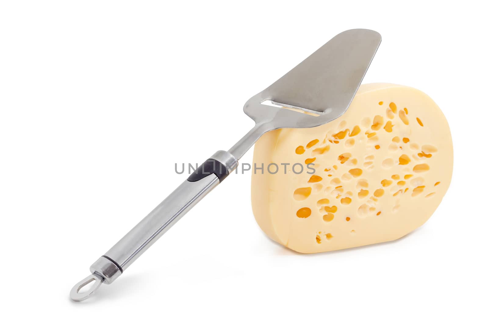 Cheese slicer on the piece of the semi-hard Swiss-type cheese on a light background
