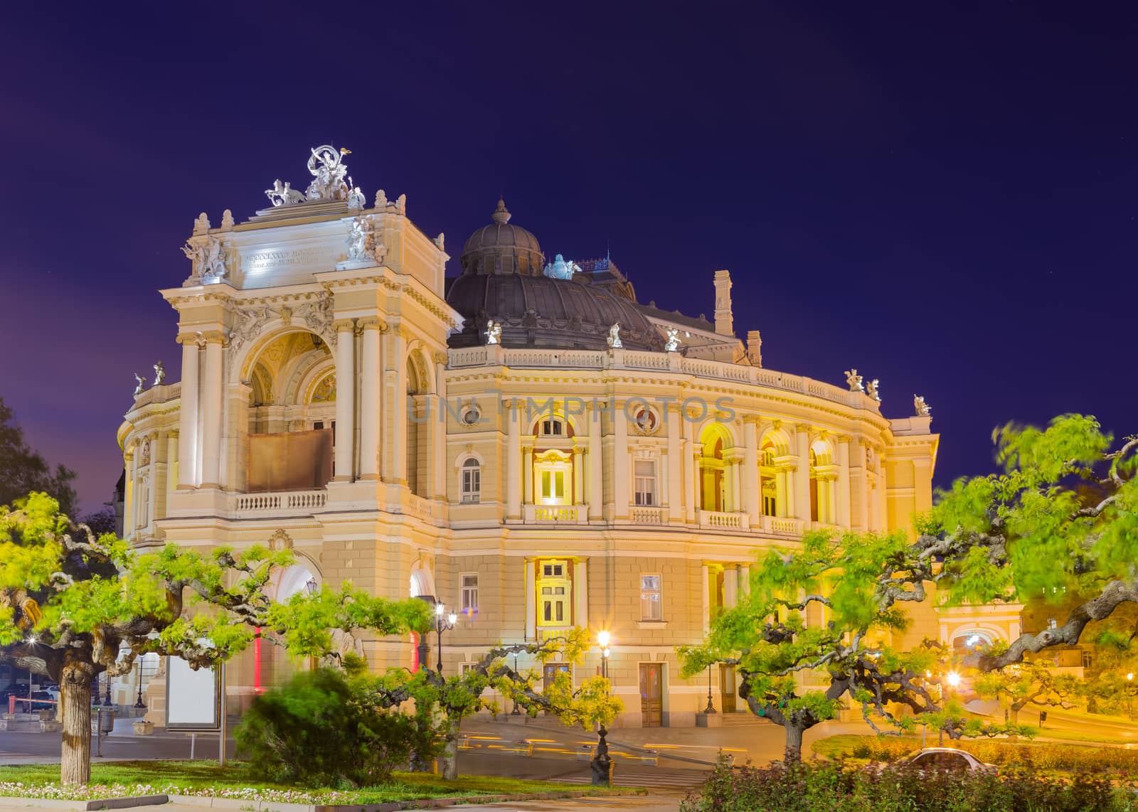 Night view of the Odessa Opera and Ballet Theater building, built in the 19th century in spring in windy weather, Ukraine
