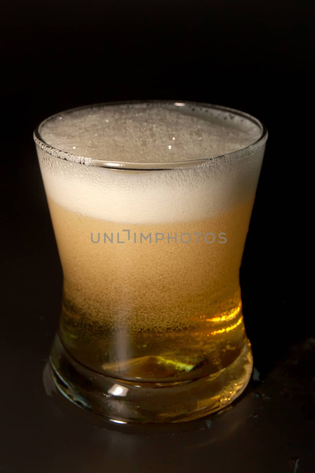 Beer in glass isolated on black background. 