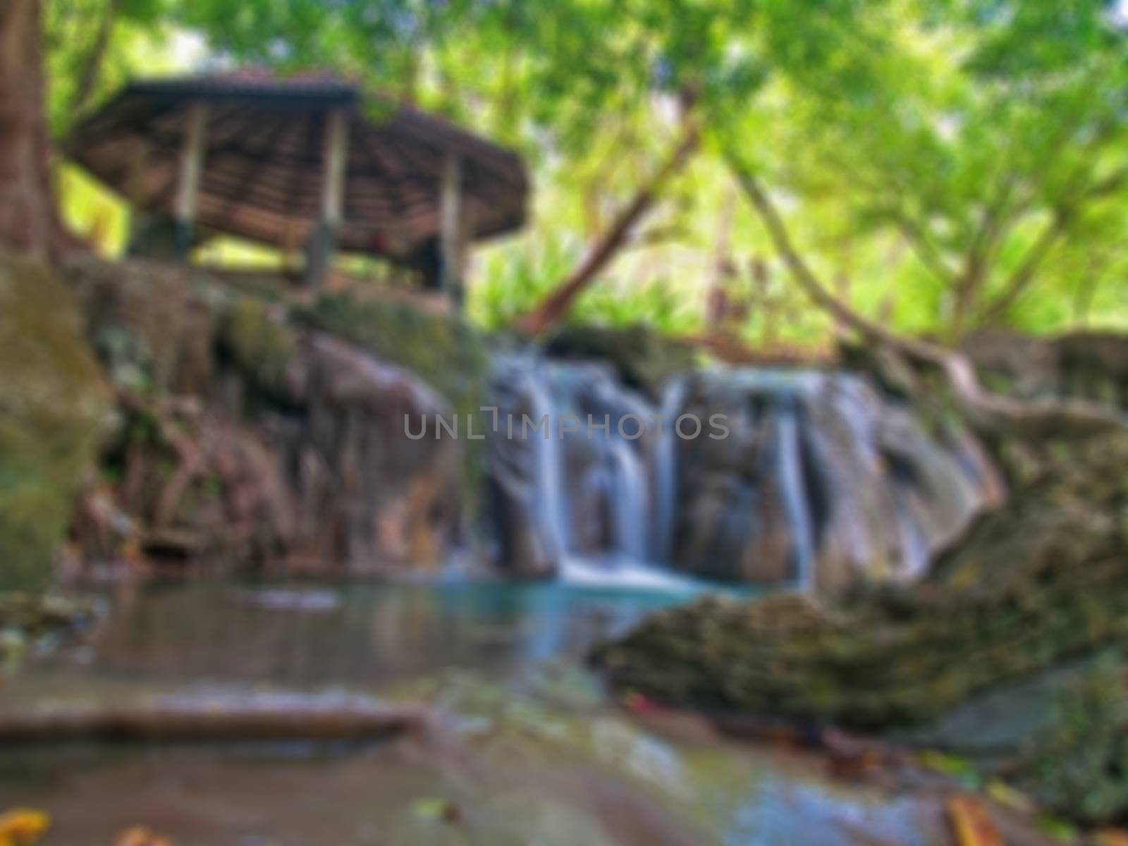 Abstract blurred waterside pavilion with waterfall.