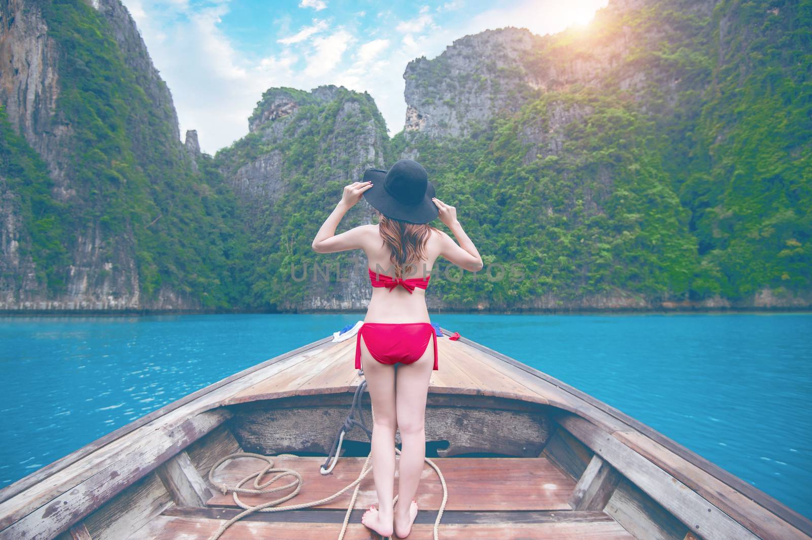 Beautiful girl in red bikini on boat. Vintage tone.