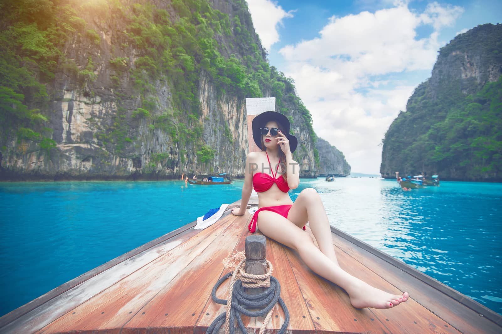 Beautiful girl in red bikini on boat. Vintage tone.