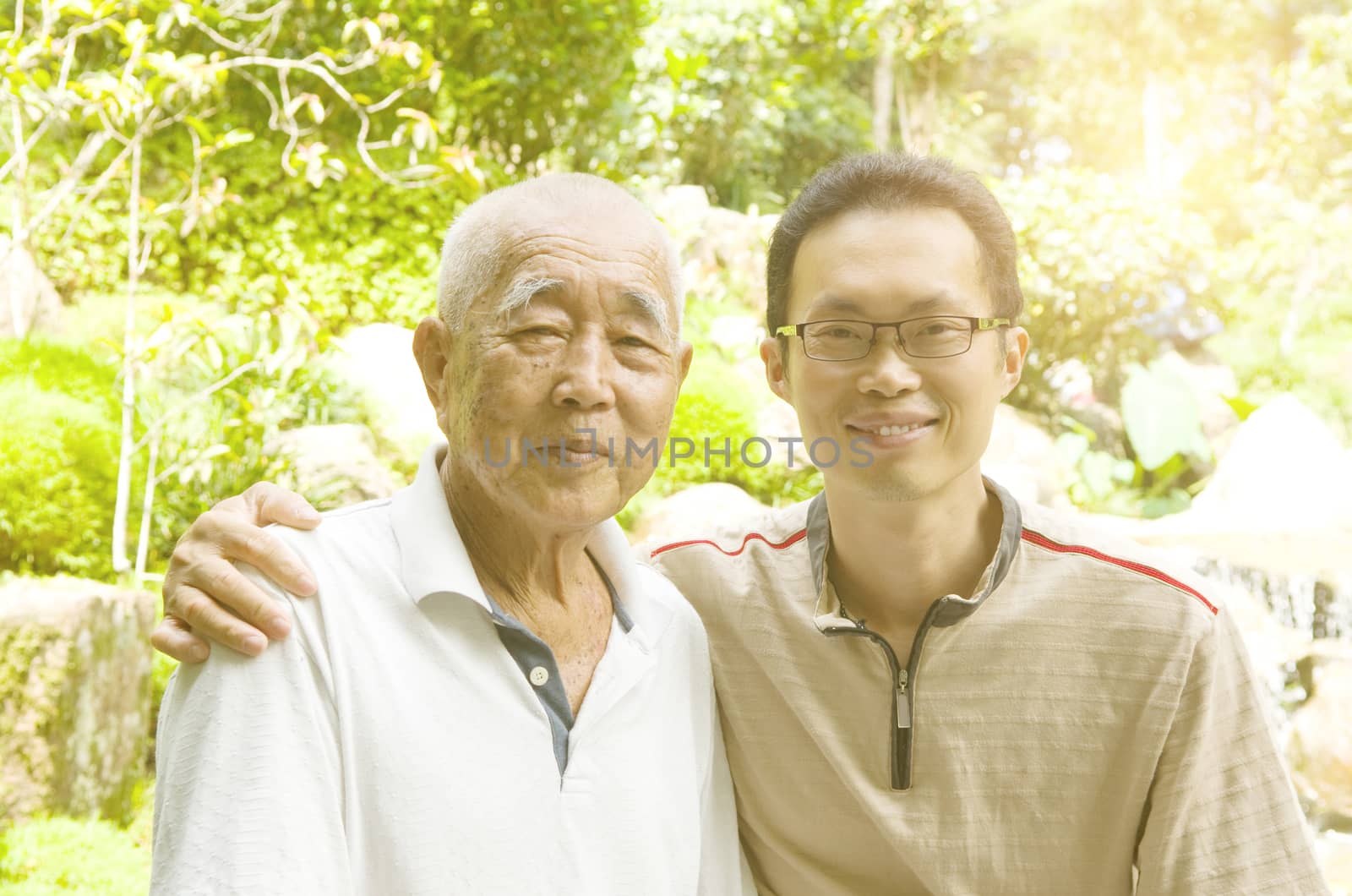 Happy asian family relaxing in the garden.