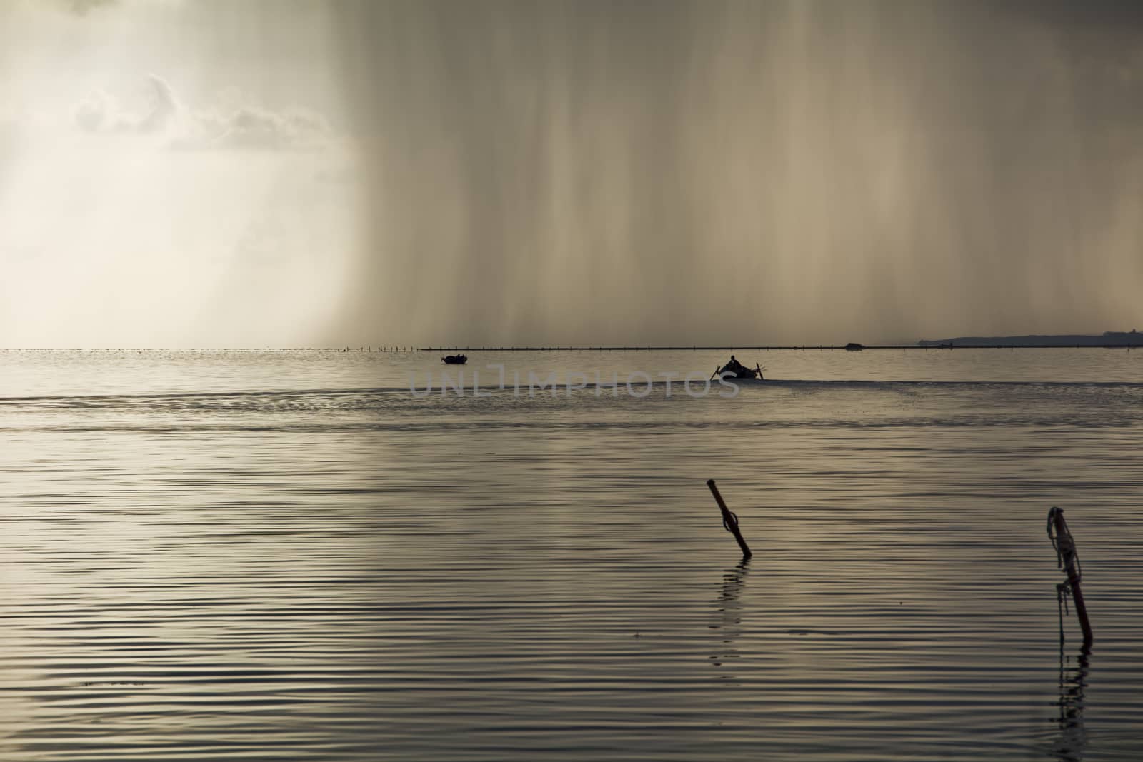 Sunset in the lagoon, where fishermen return to the approach of the impending storm. Dawning. Mediterranean islands.