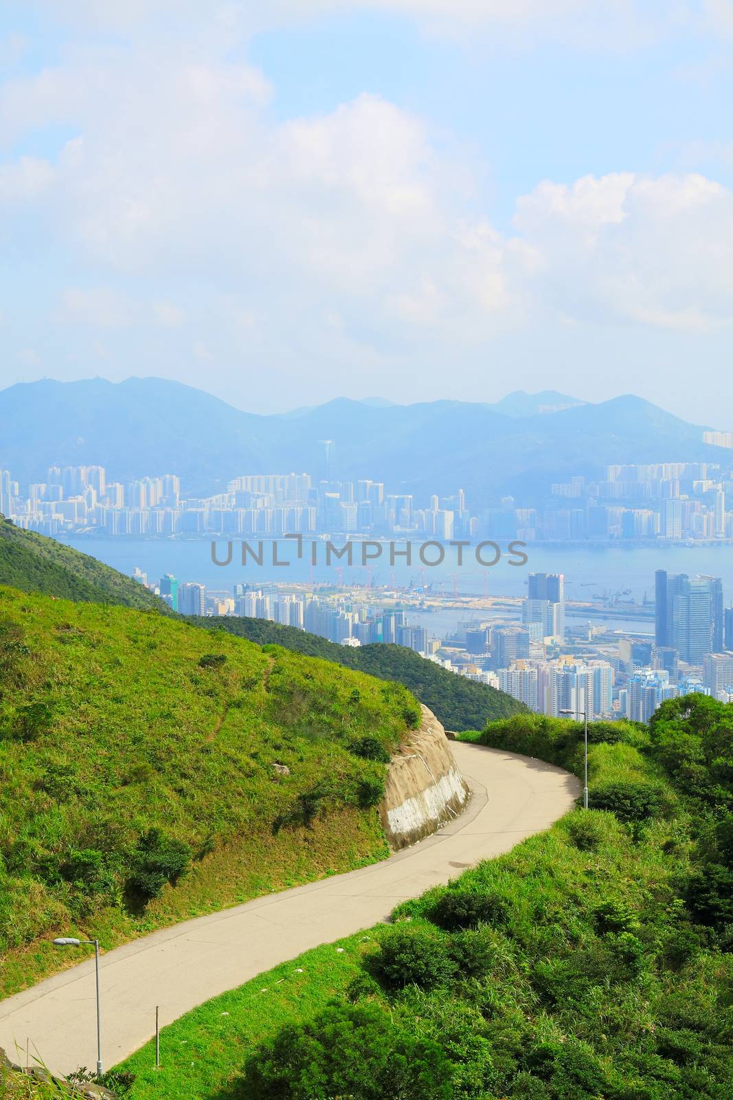 Asphalt winding curve road to city by cozyta