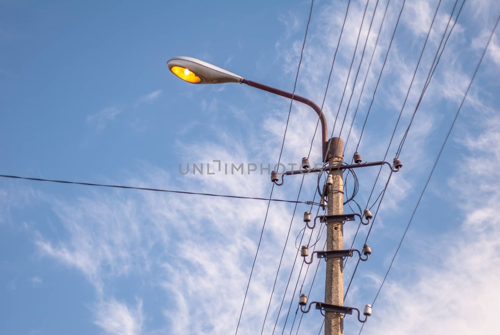 vintage electric pole in a sunny day against the blue sky