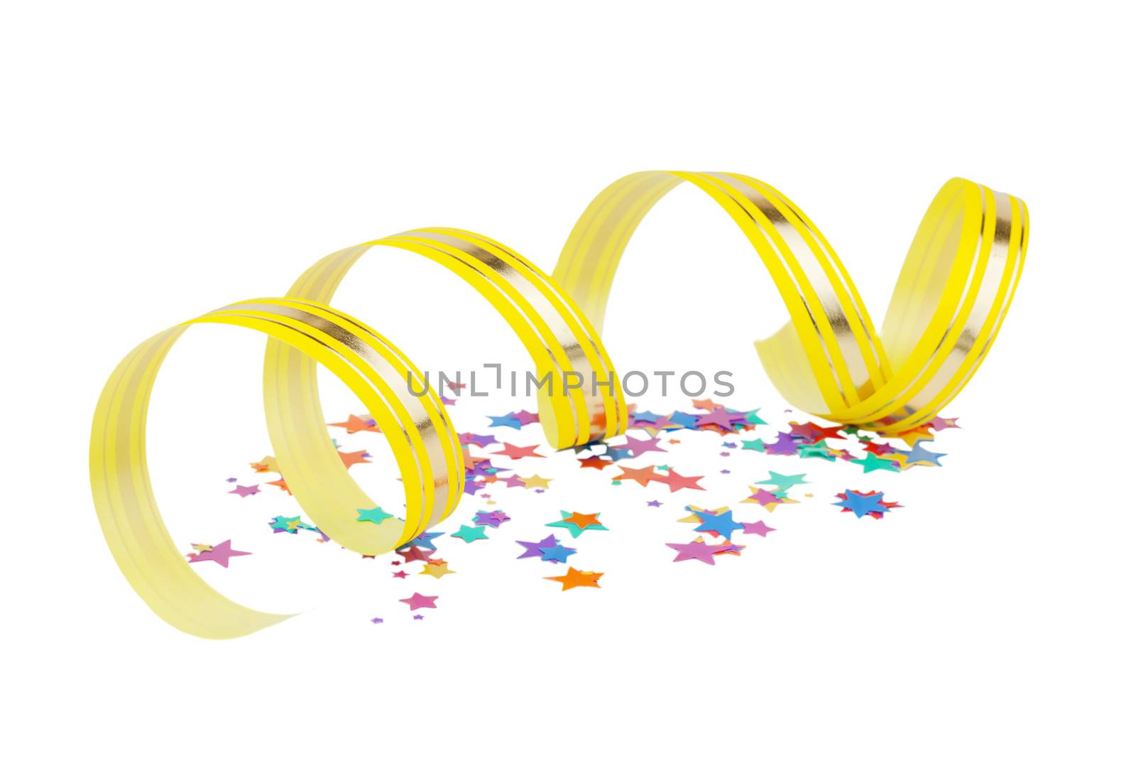 Multicolored confetti in the shape of stars and yellow ribbon with golden stripes coiled as a spiral isolated on white background