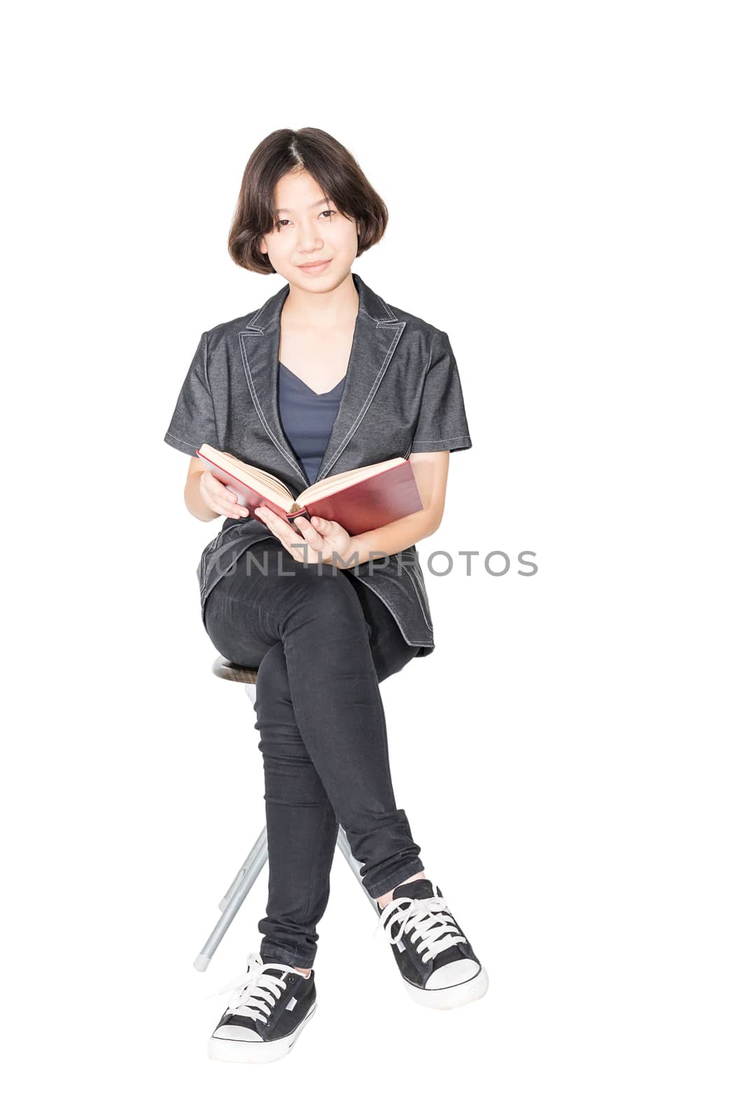  Woman reading a book sitting on chair by stoonn