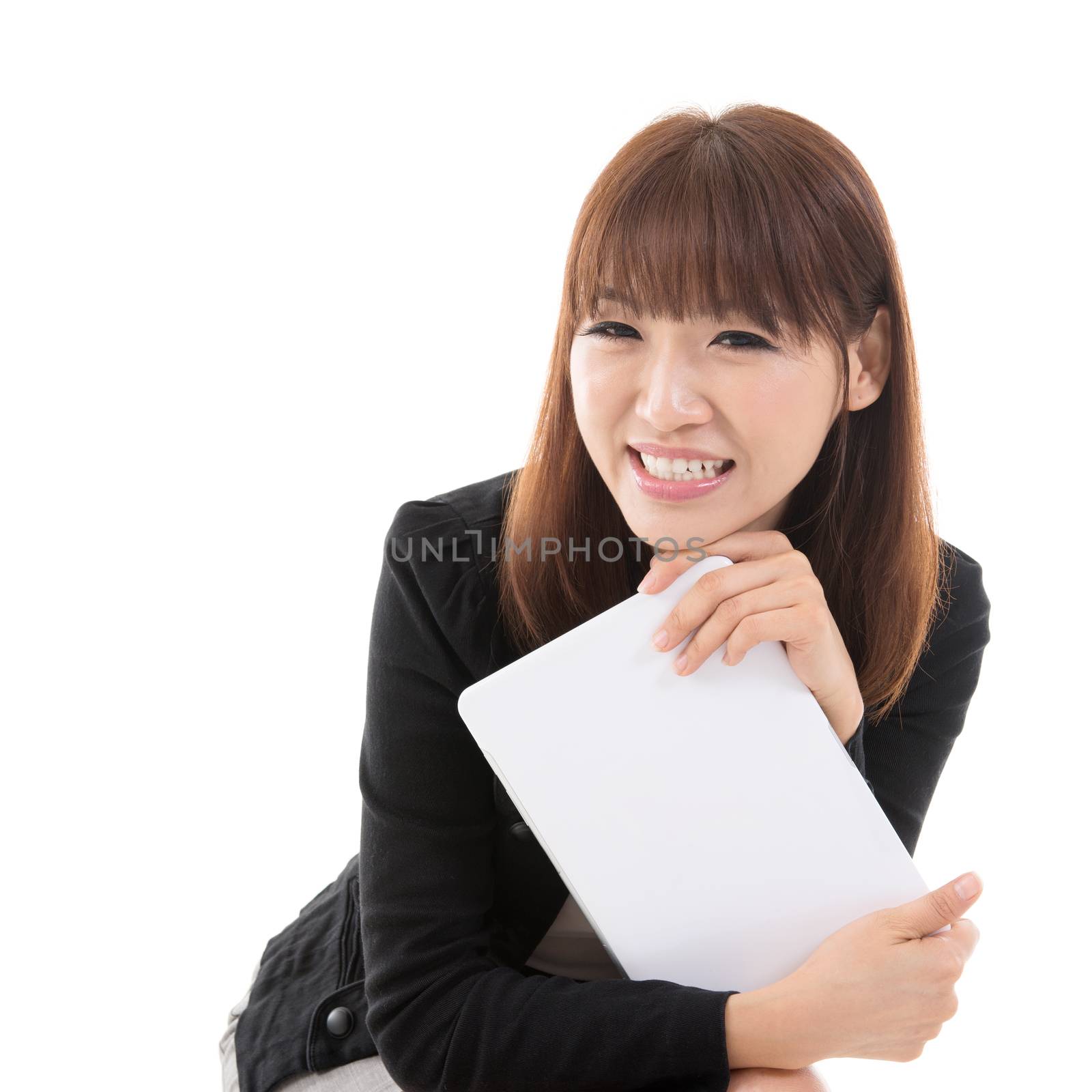 Young Asian girl holding digital computer tablet and smiling, isolated on white background.