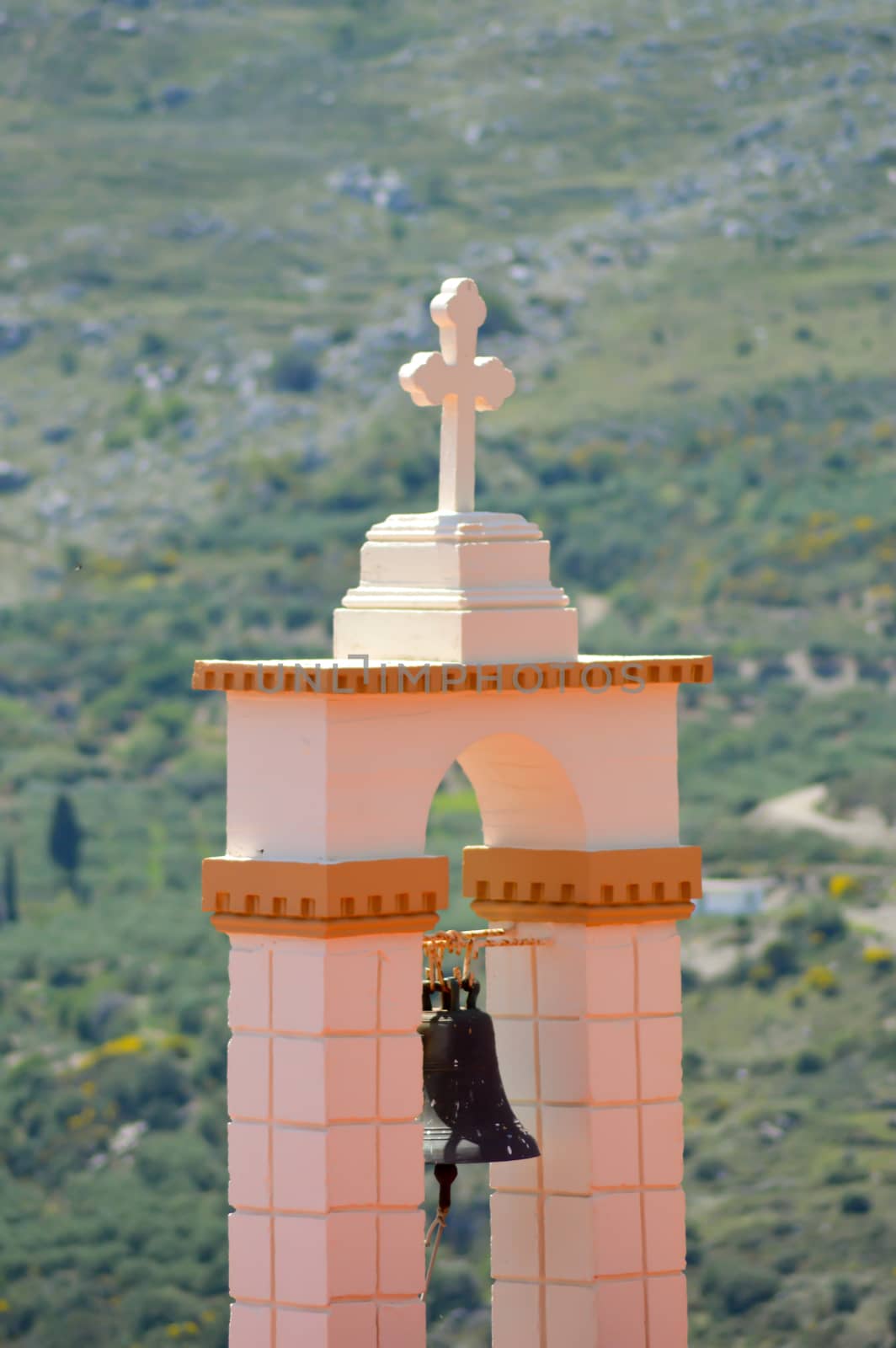 Outside bell of a Greek Orthodox church with the mountain in the background