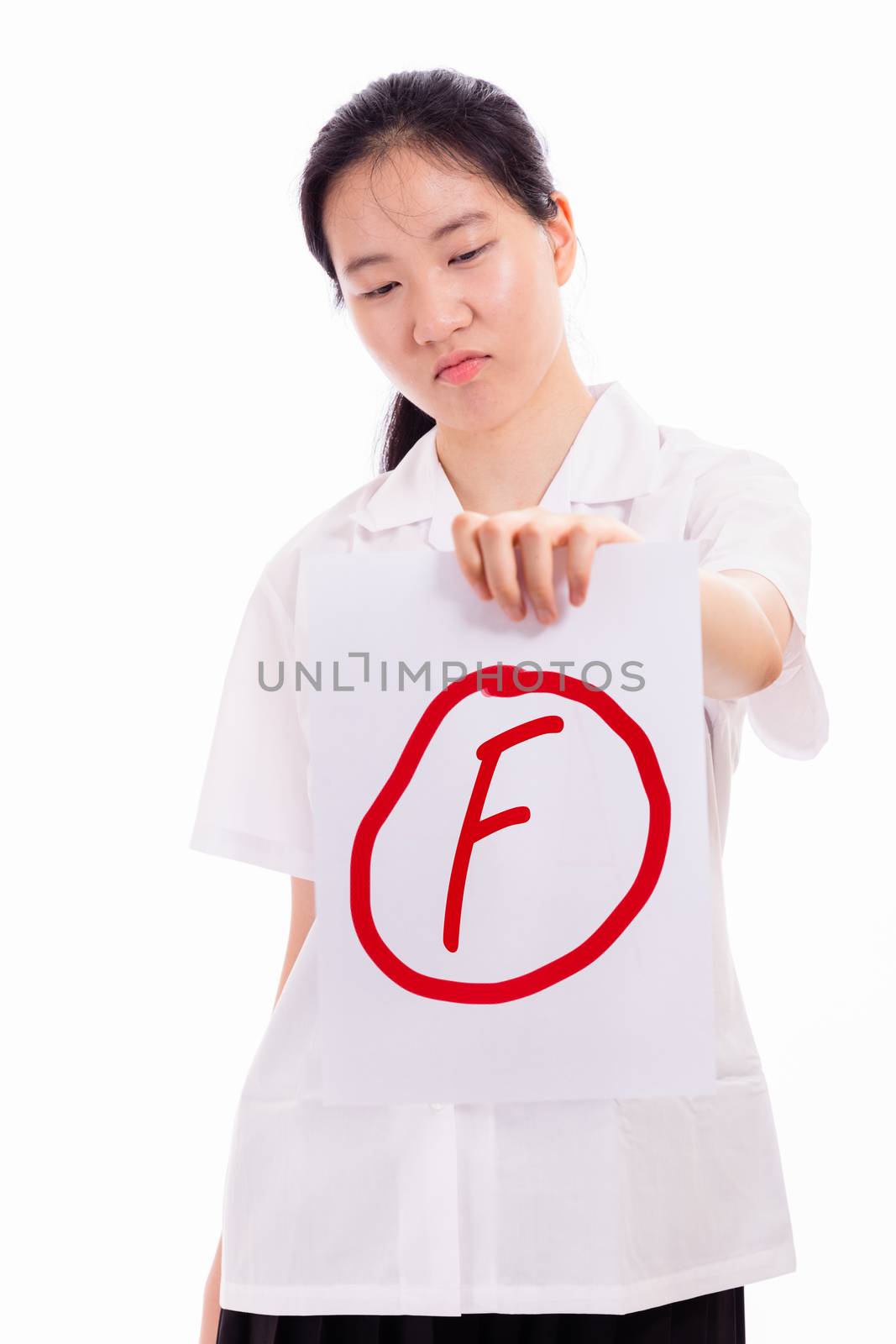 Chinese high school girl in uniform showing failed test paper