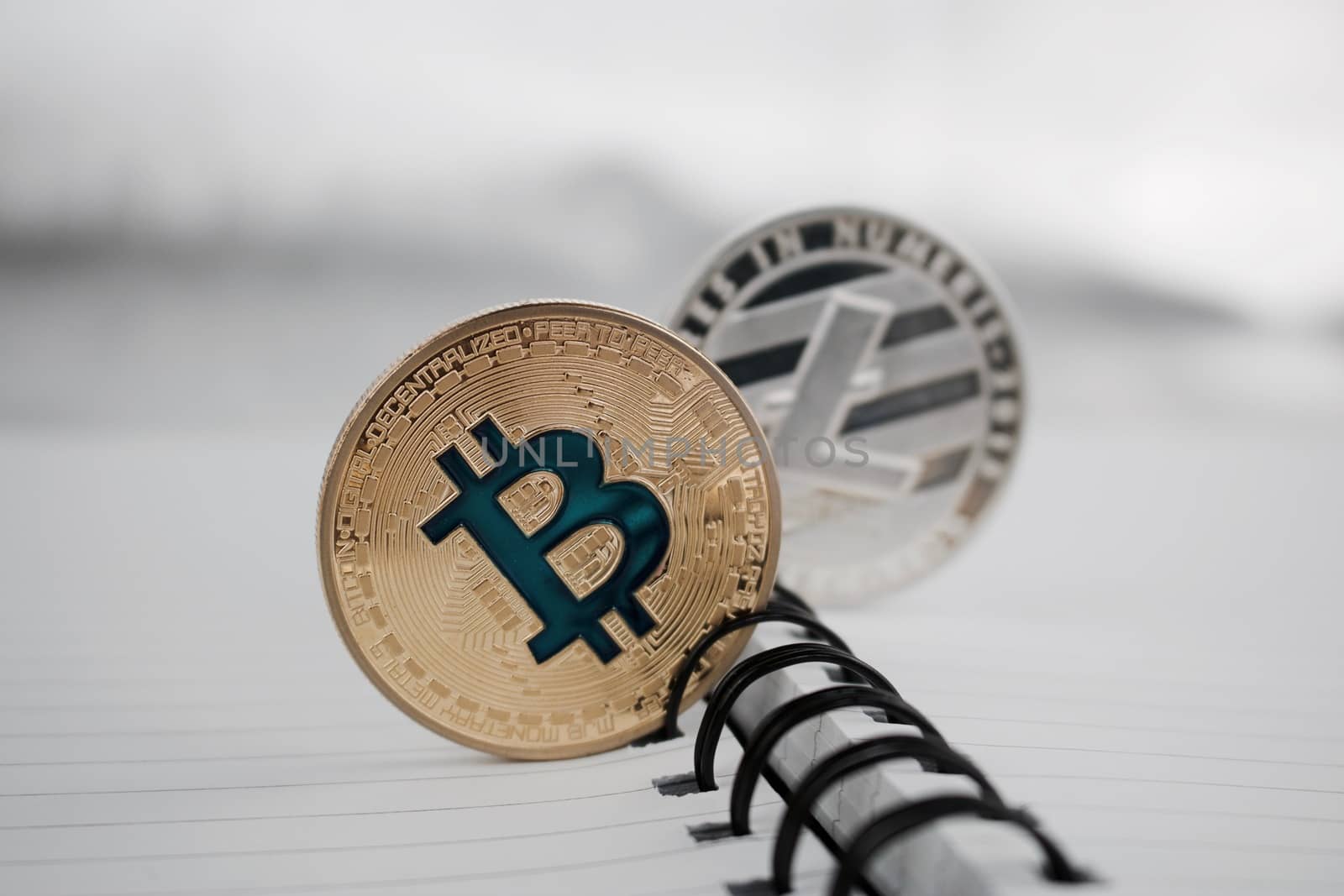 Cryptocurrency physical gold bitcoin and silver litecoin coins.