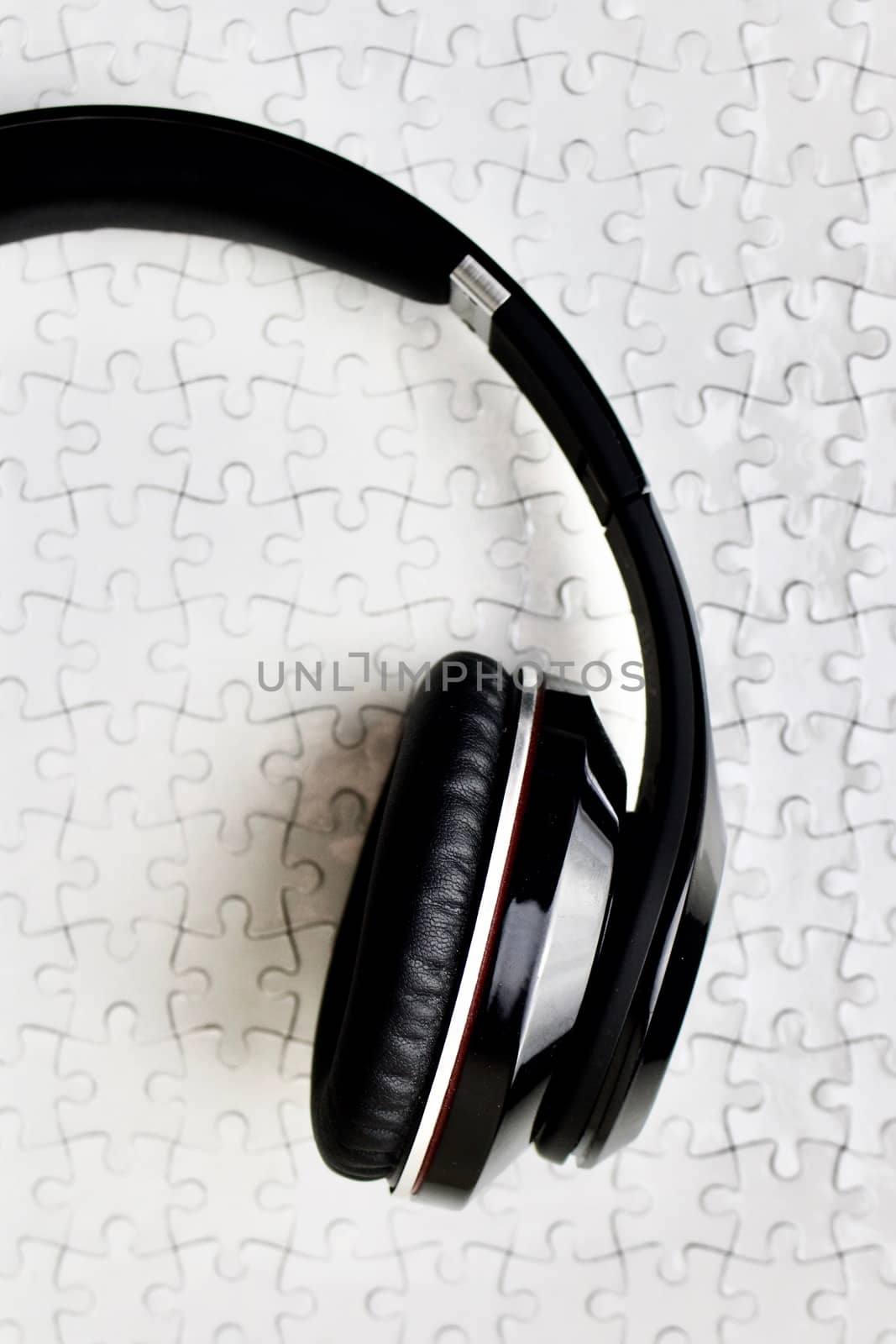 Black headphones on white puzzles