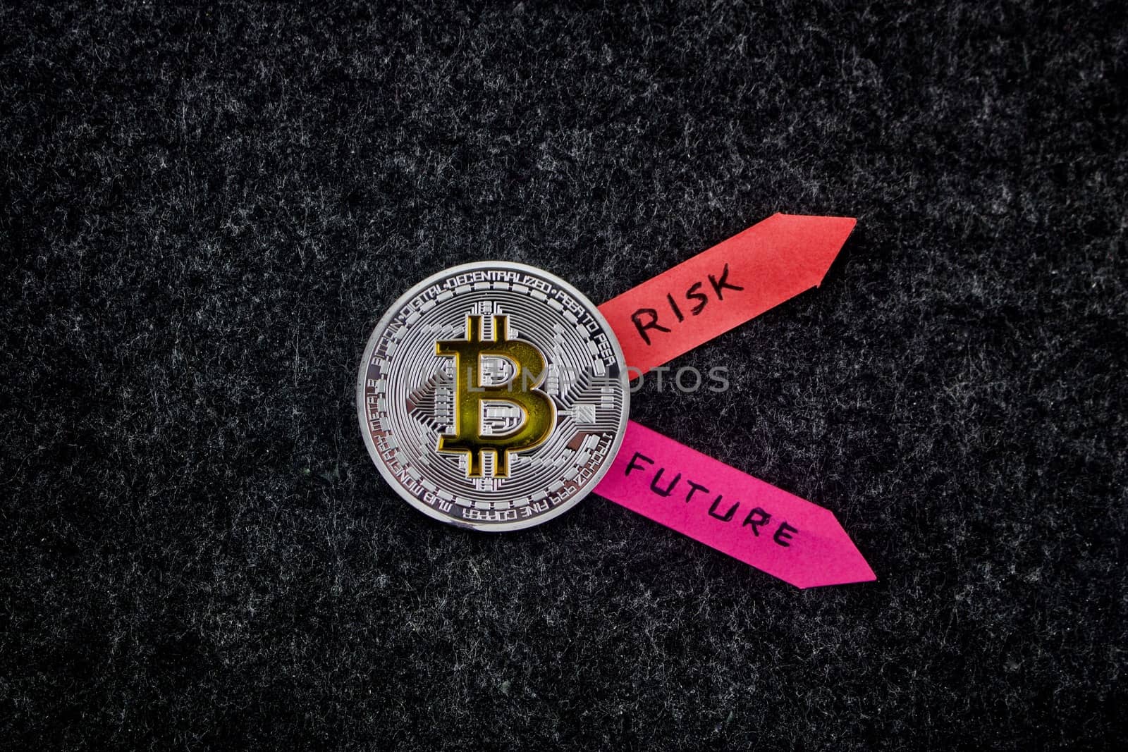 Cryptocurrency physical silver bitcoin coin with two colorful arrows.