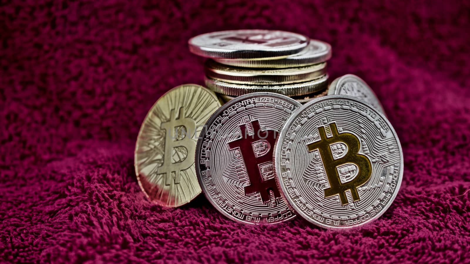 Digital currency physical bitcoin coins in pink scene