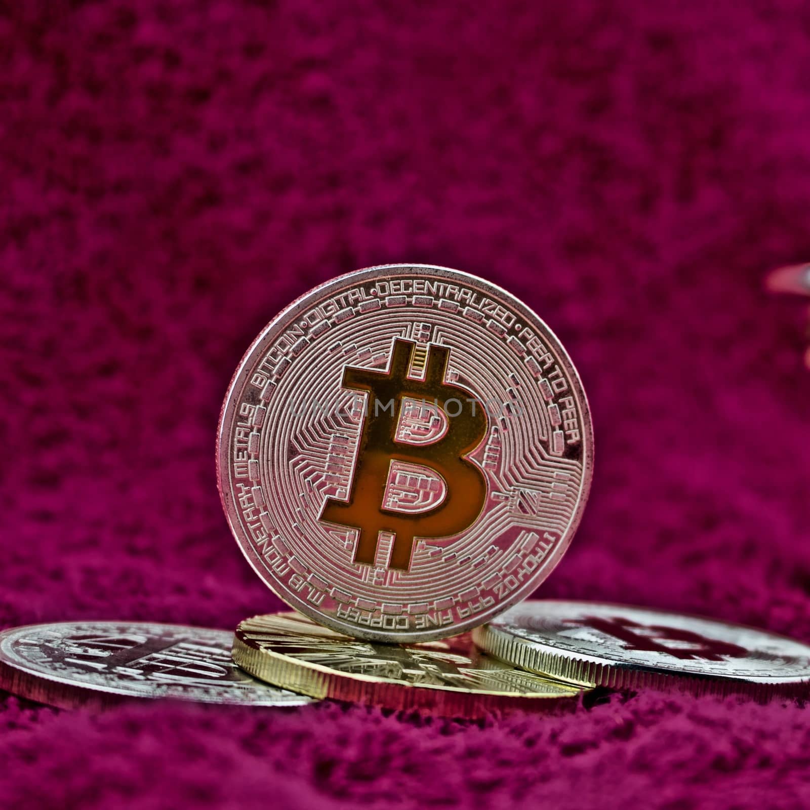 Cryptocurrency physical silver bitcoin coin in pink scene