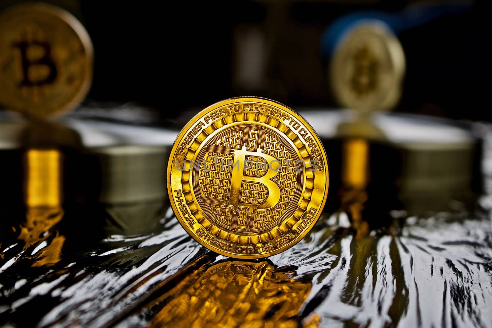 Cryptocurrency physical gold bitcoin coin in black scene
