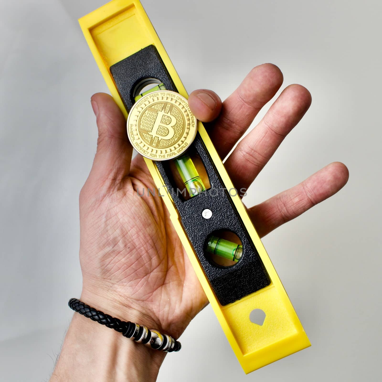 Level scale with bitcoin coin in hand