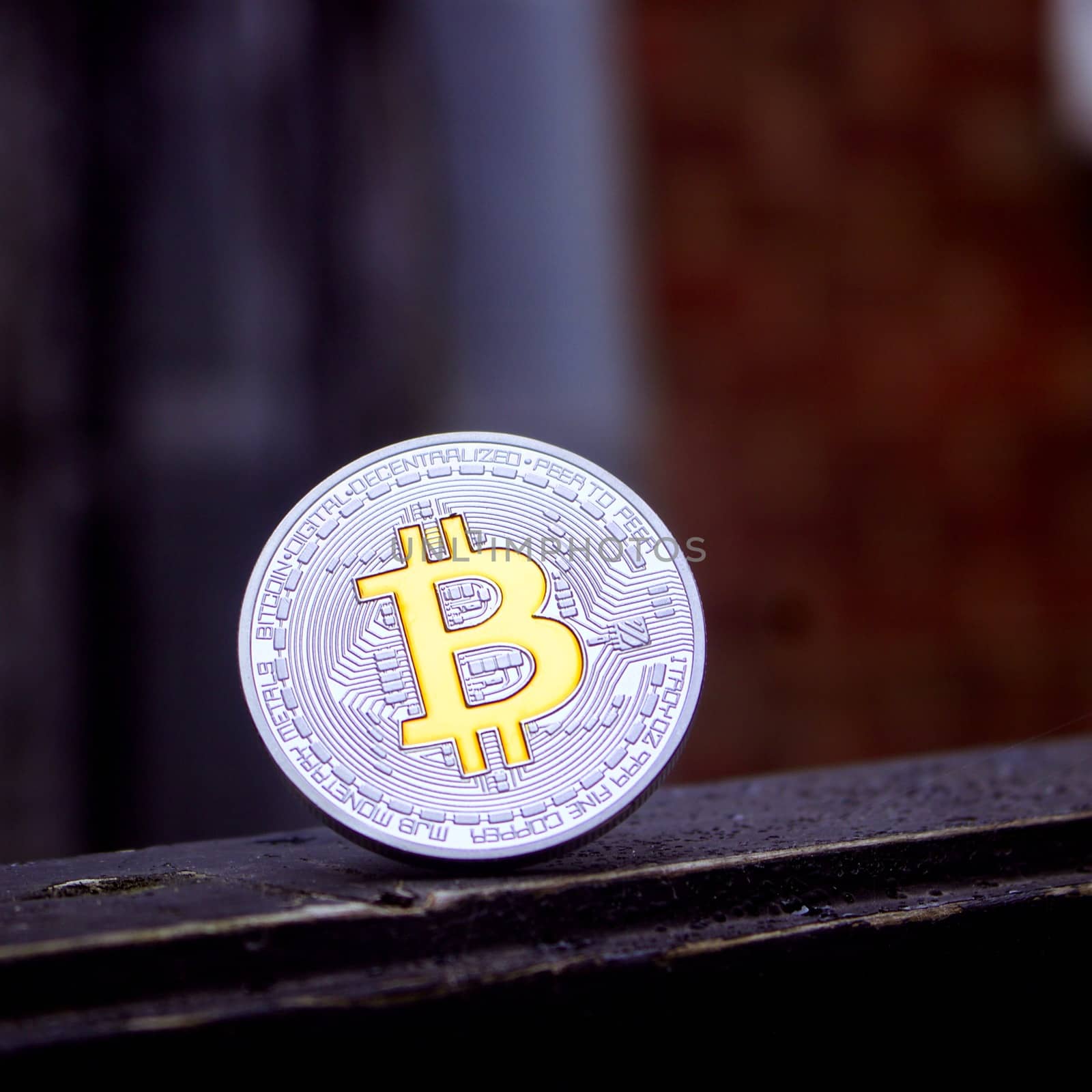 Cryptocurrency silver bitcoin coin with yellow currency sign.