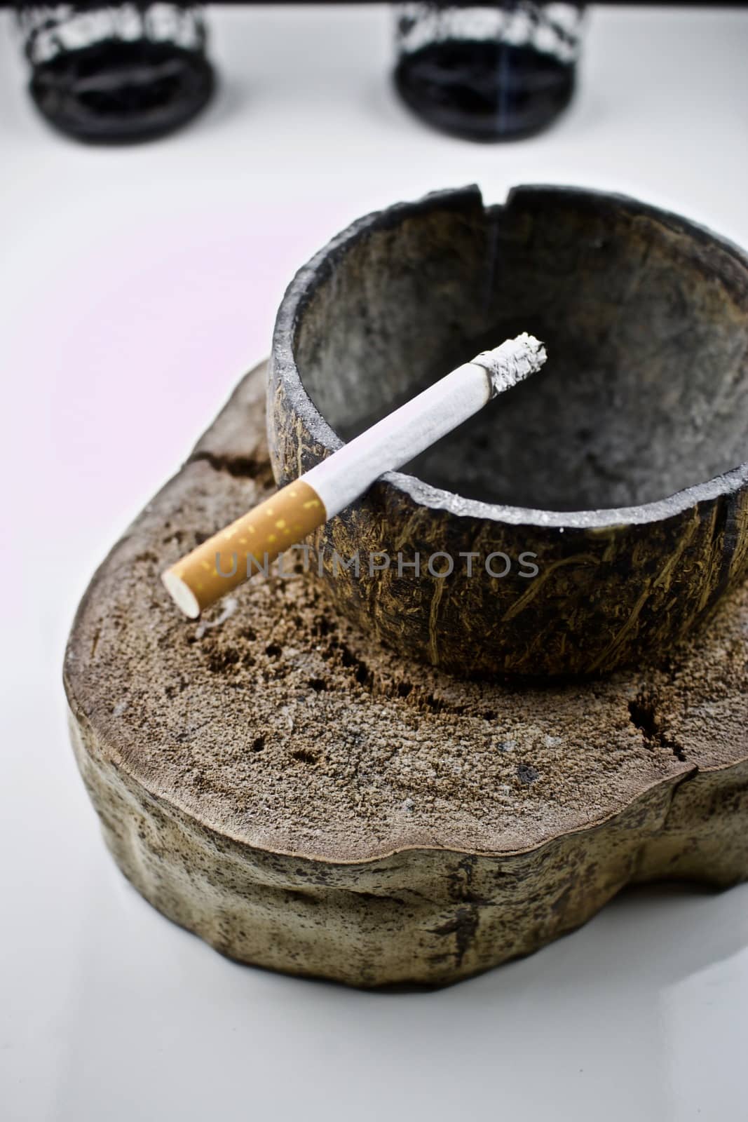 Cigarette in coconut handmade ashtray
