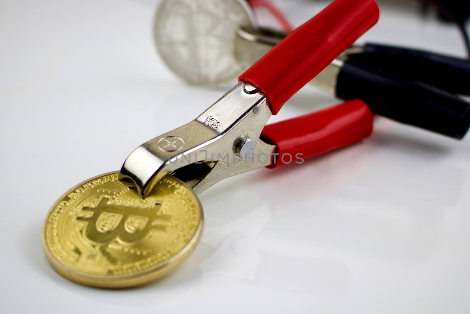 Gold cryptocurrency physical coin with electrical cables