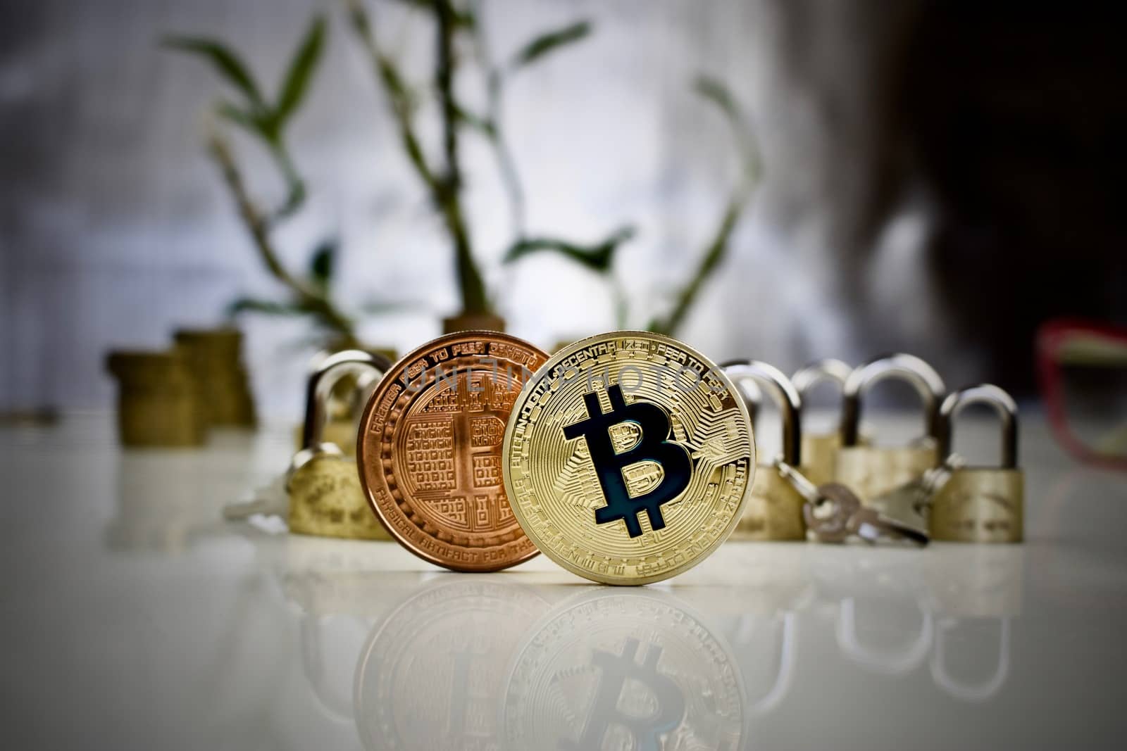 Digital currency brass and gold bitcoin coins near padlocks