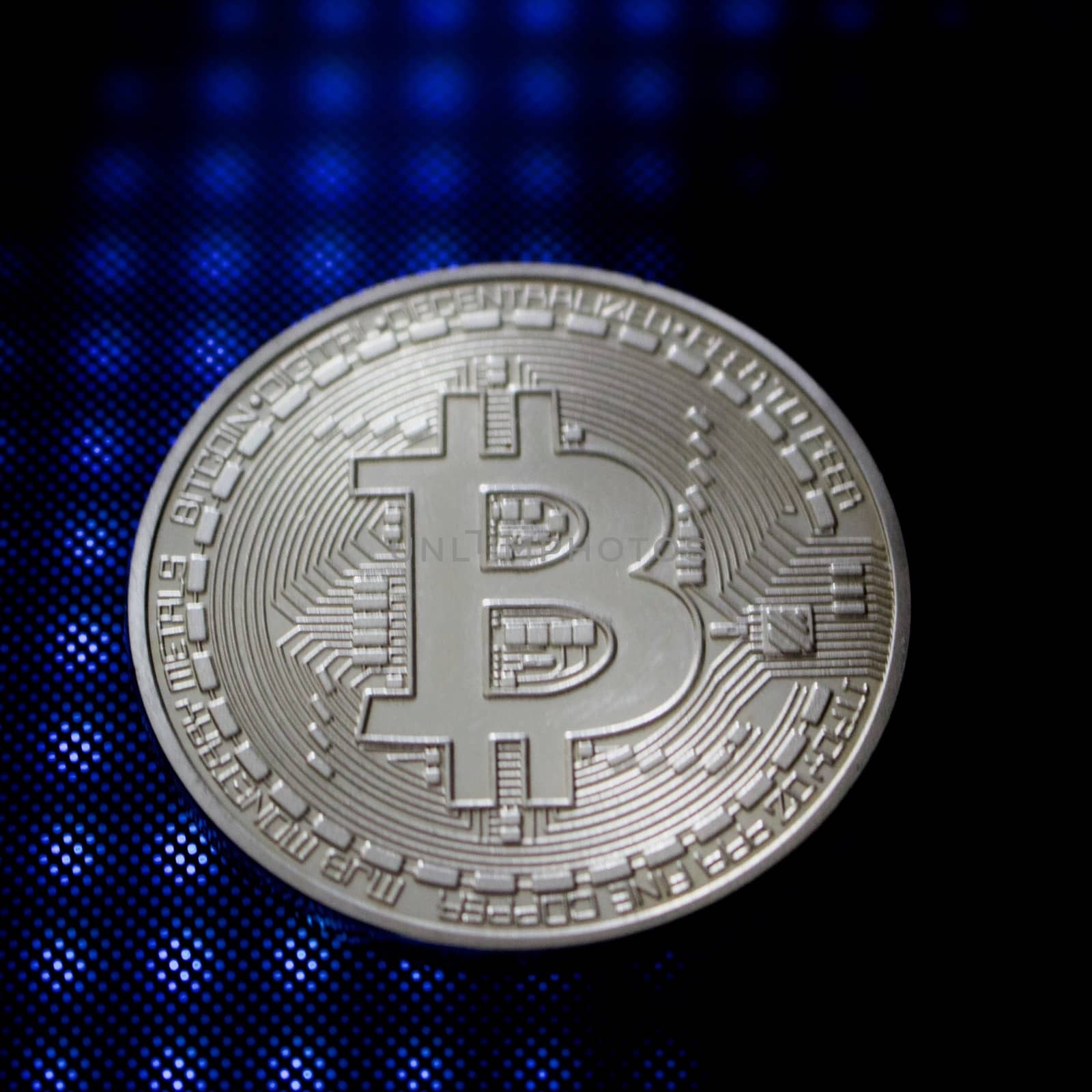 Blue light and silver physical bitcoin coin