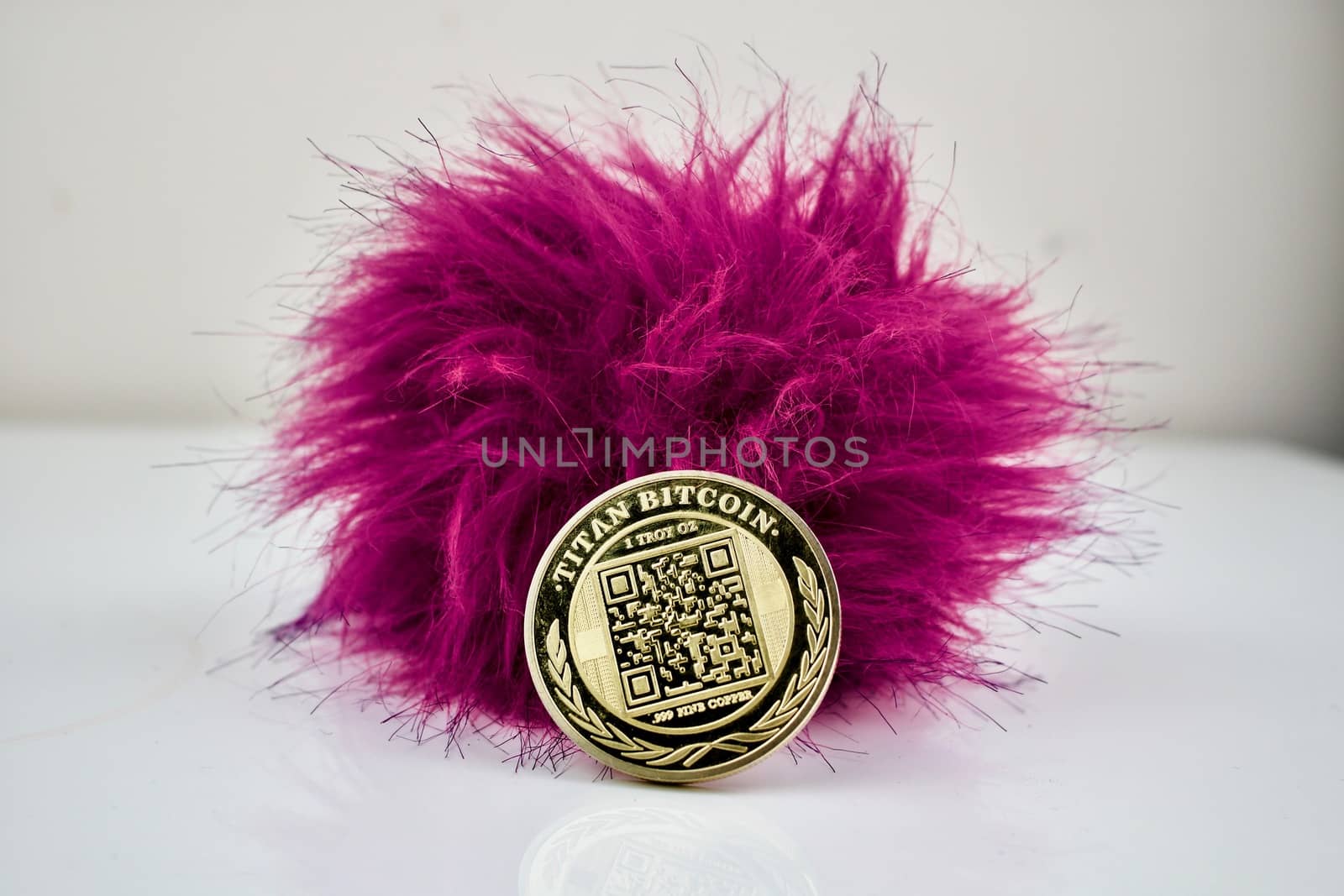 Hairy pink ball and one gold titan bitcoin cryptocurrency