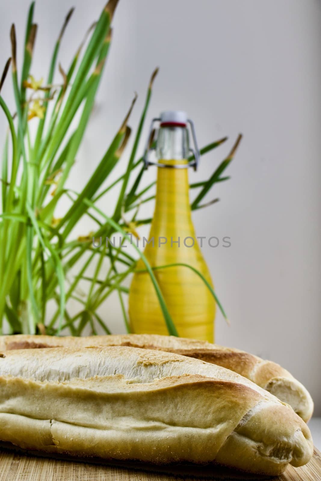 Green flower, fresh rolls and yellow old bottle