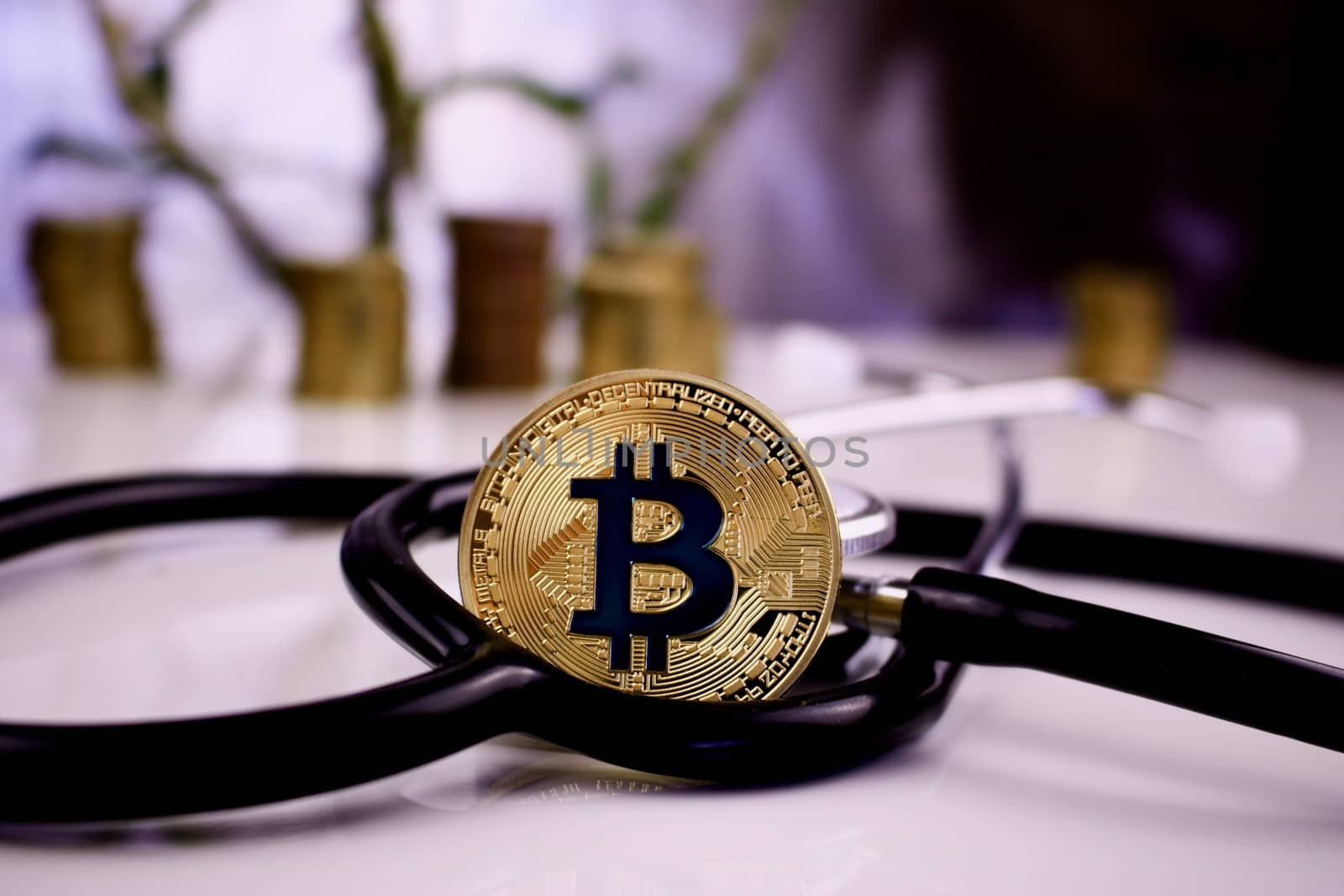 Digital currency physical gold bitcoin coin in medical stethoscope concept