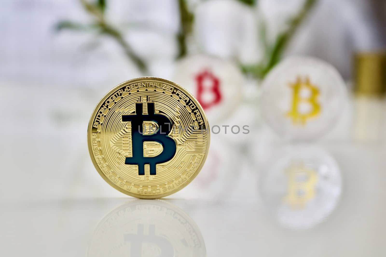 Cryptocurrency physical colored bitcoin coins. Pink bitcoin, blue bitcoin and yellow bitcoin