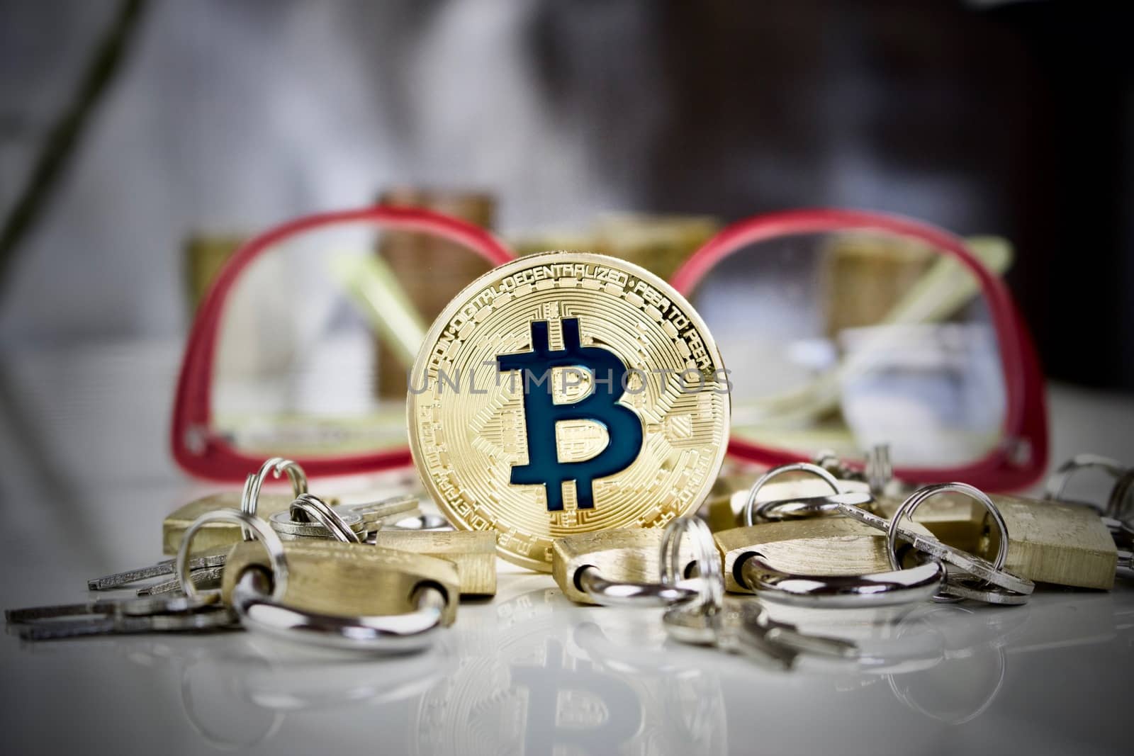 Cryptocurrency physical gold bitcoin coin around padlocks