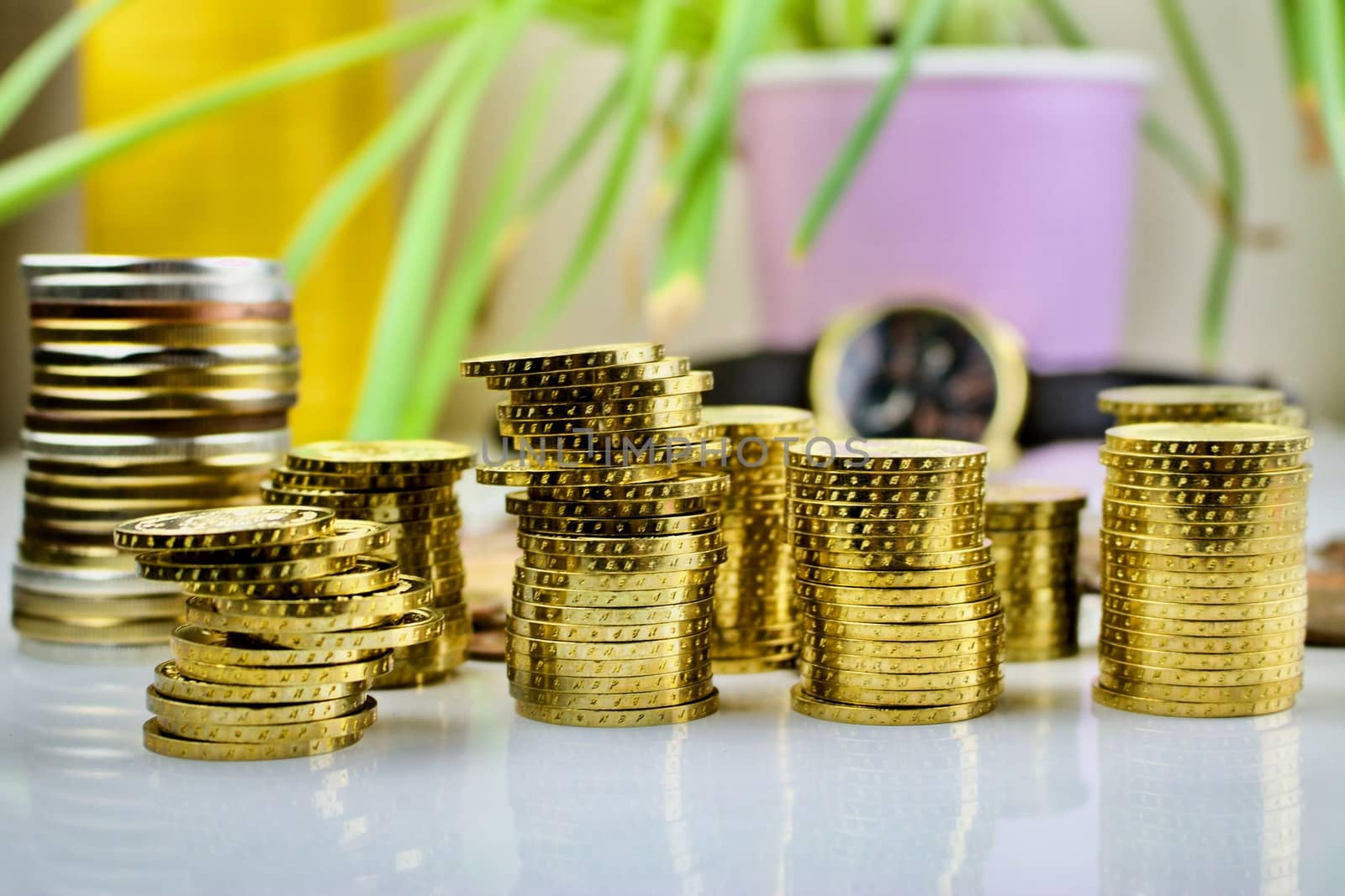 Gold coins near watch, money composition