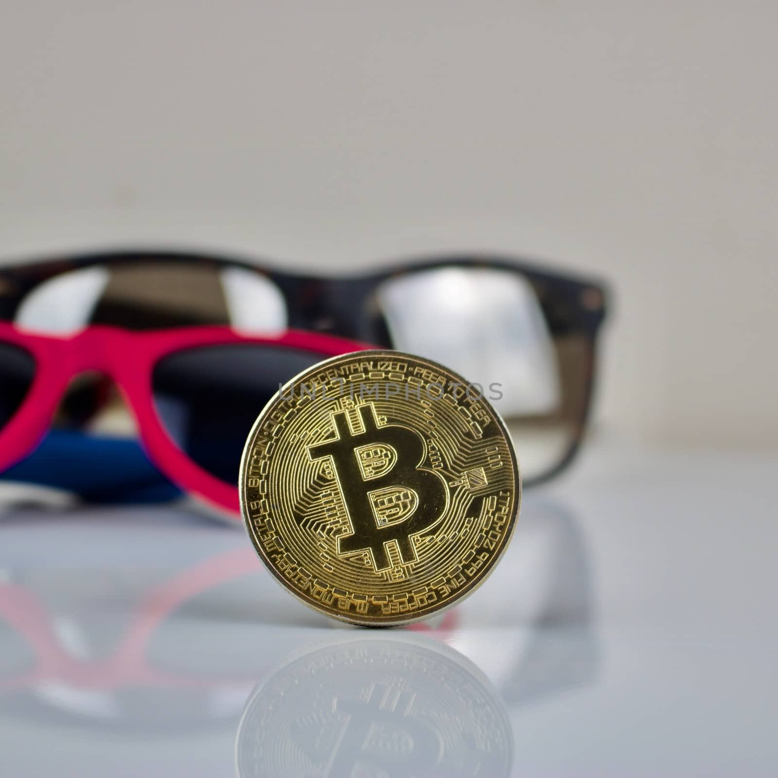 Cryptocurrency gold bitcoin coin and sunglasses