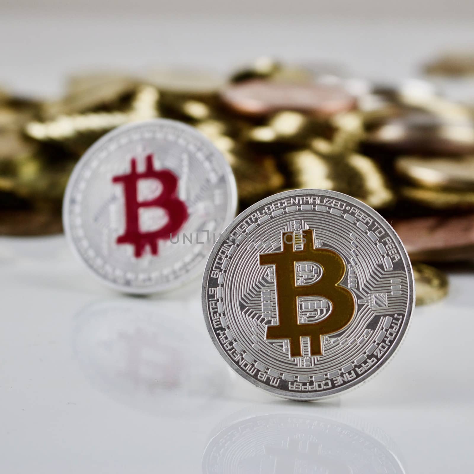 Cryptocurrency physical silver bitcoin coins near other gold money