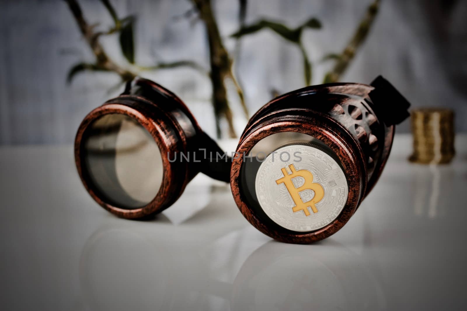 Cryptocurrency physical silver bitcoin coin - steampunk glasses composition
