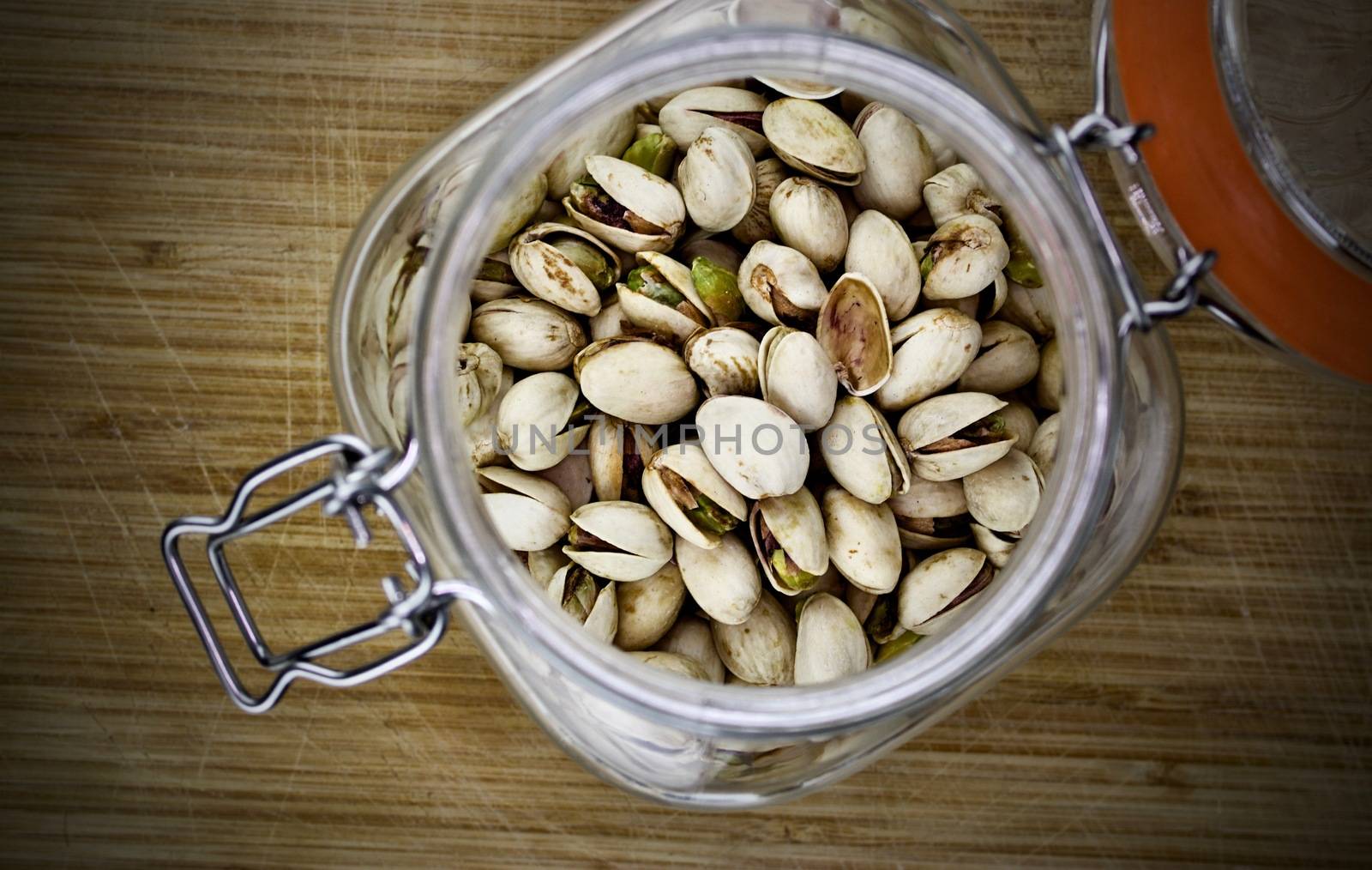 Fresh pistachios in big glass kitchen jar