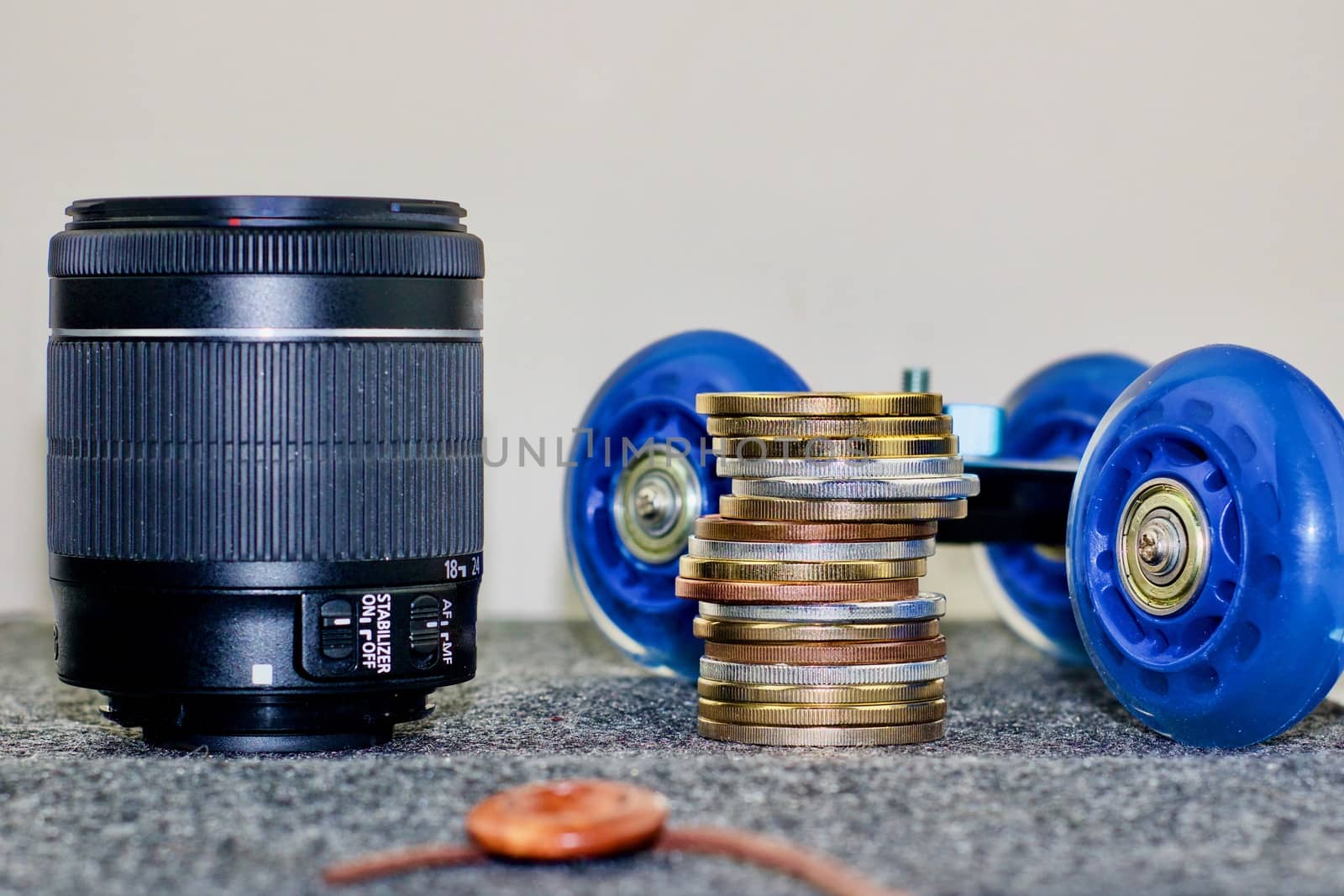 Black dslr camera lens, camera trolley and coins money.