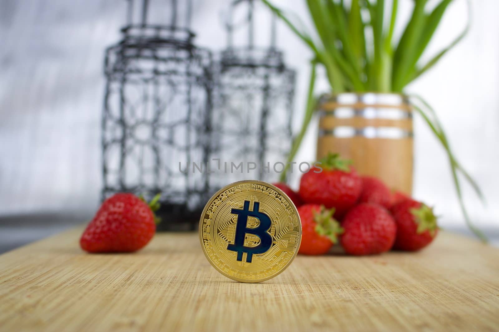 Cryptocurrency physical gold bitcoin coin strawberry concept.