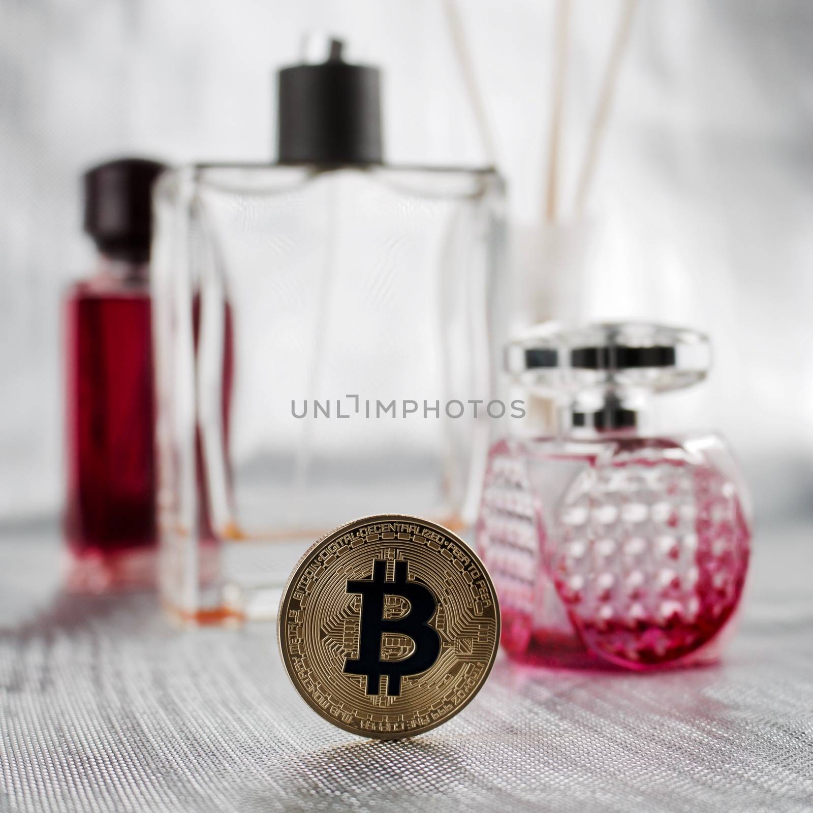 Digital currency physical gold bitcoin coin. Perfume composition.