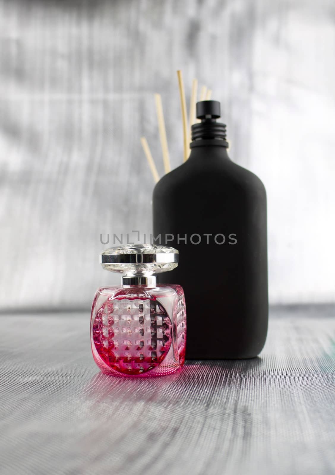 Pink and black fragrance. Perfume composition on the table.