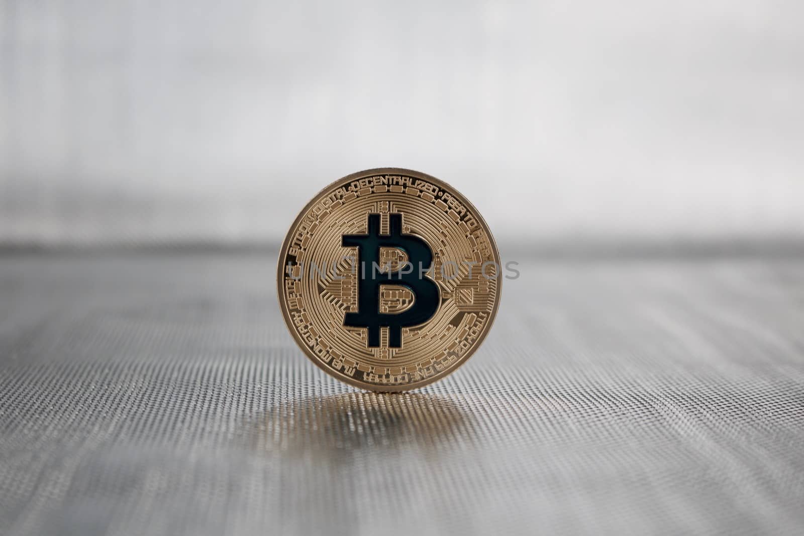 Cryptocurrency physical gold bitcoin coin with a dark blue sign