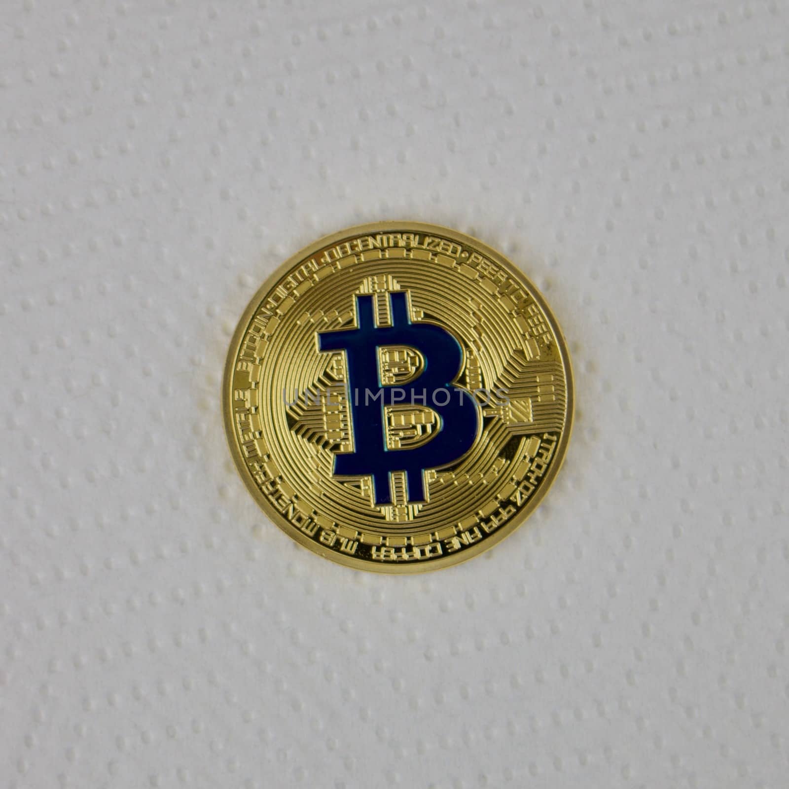 Digital currency physical gold bitcoin coin with a blue sign.