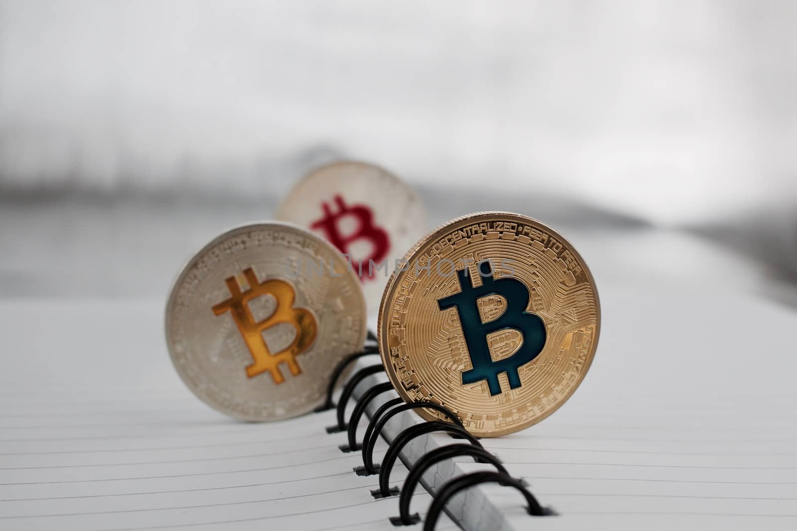 Digital currency physical silver and gold colored bitcoin coins.