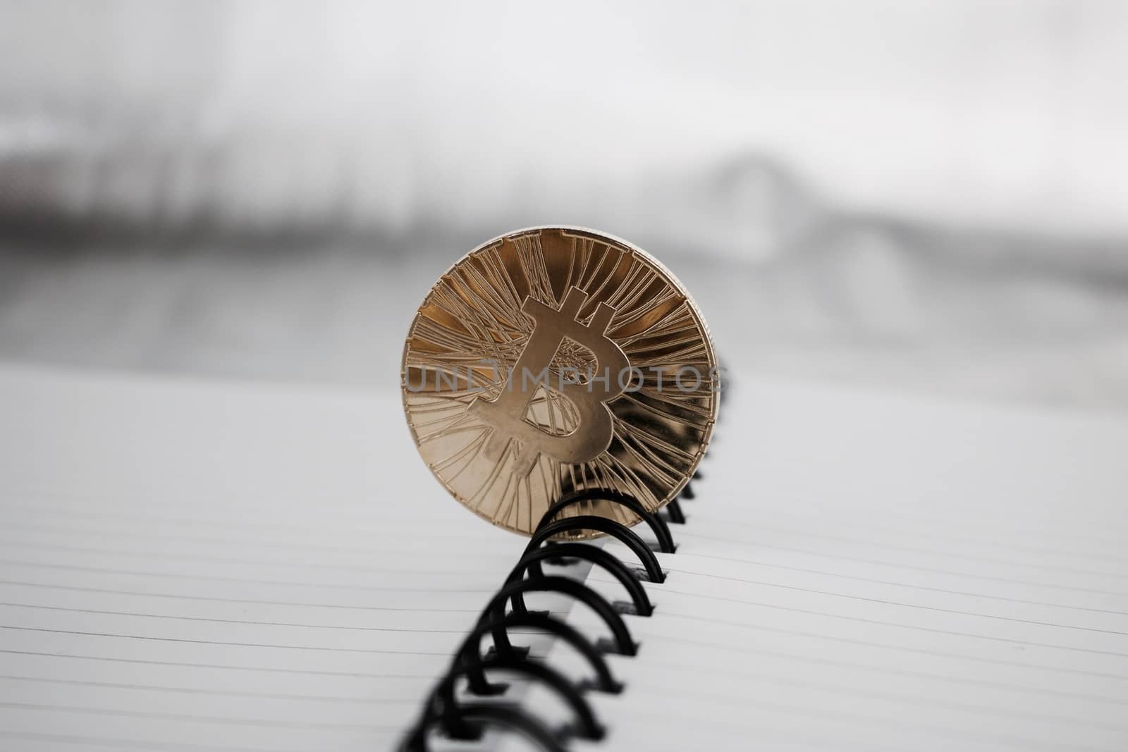Digital currency physical gold bitcoin coin in notebook.