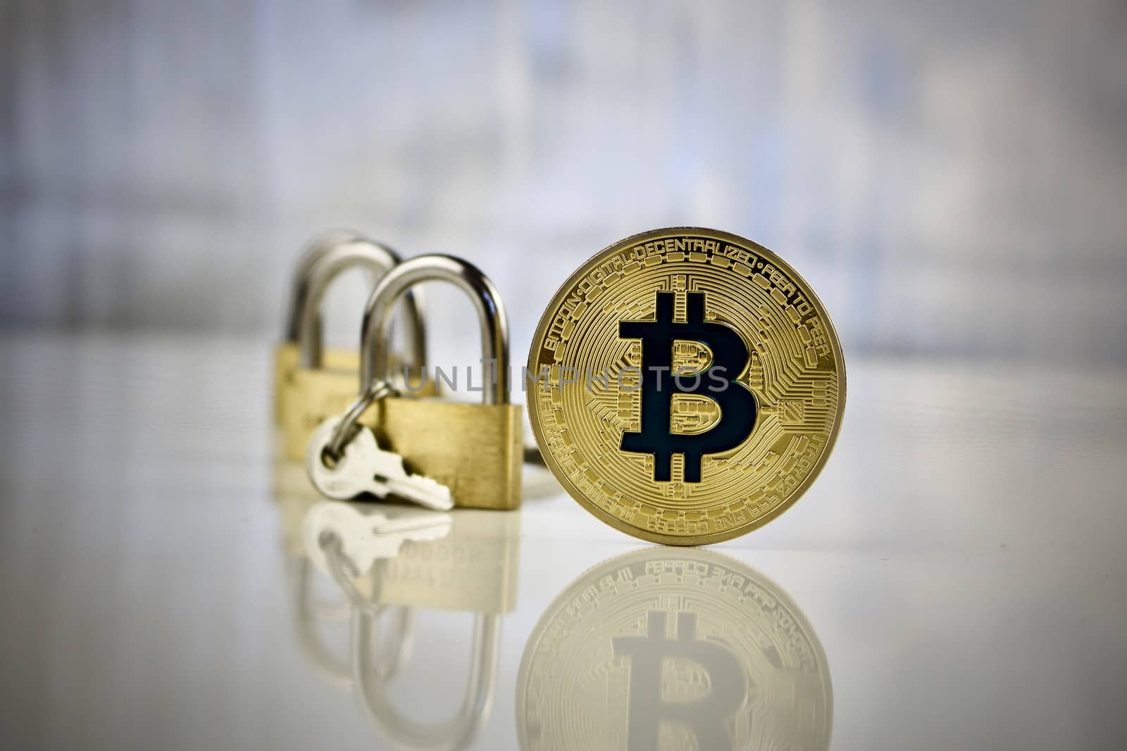 Digital currency physical gold bitcoin coin - padlocks concept.