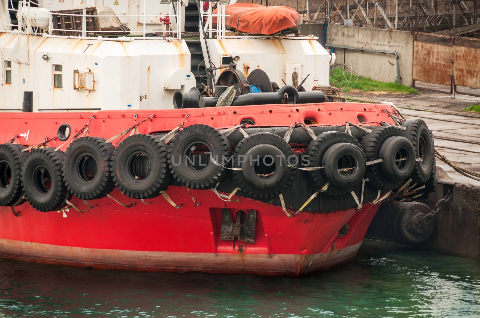 Old tires on bow ship. used for impact protection of a ship.