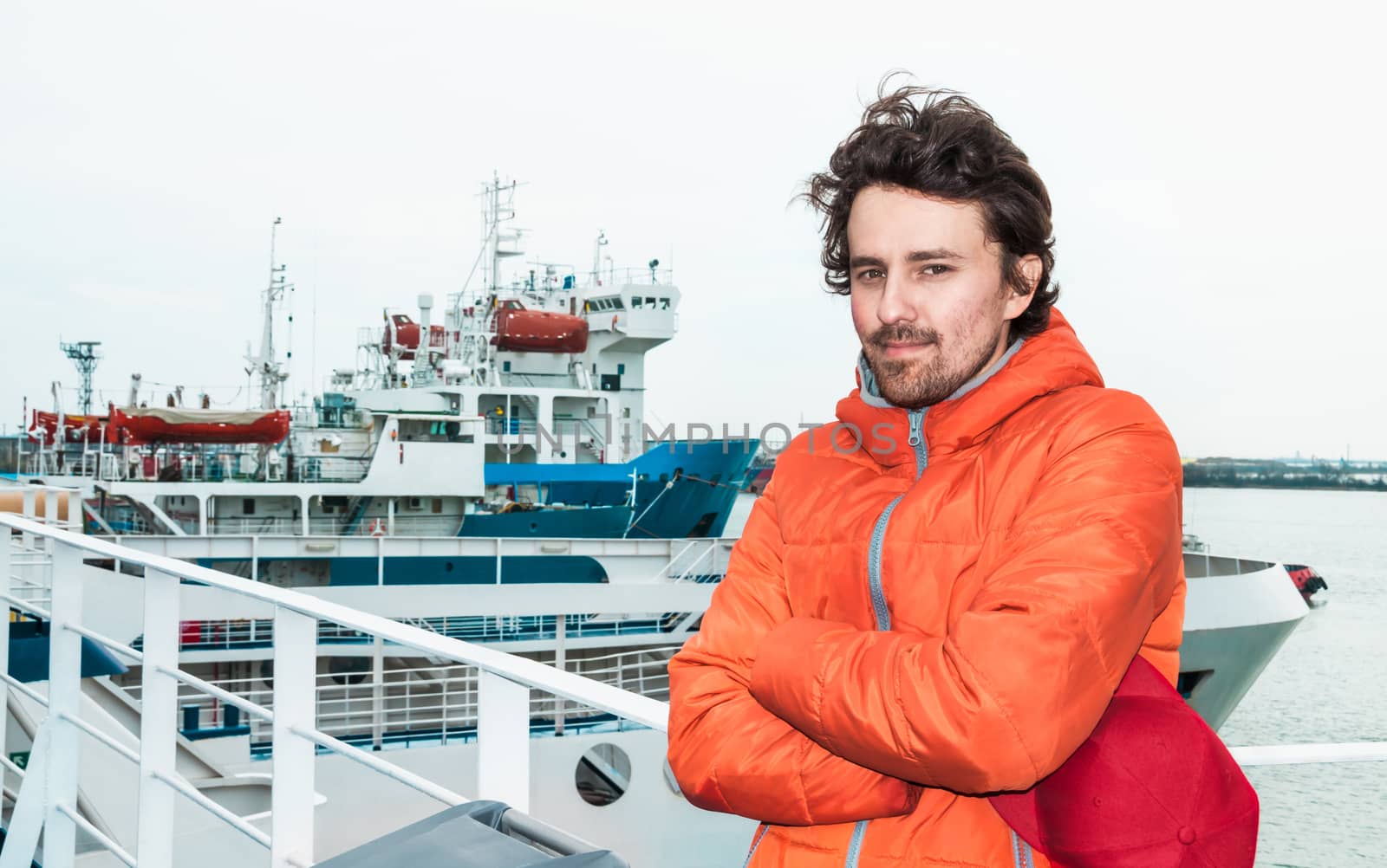 Portrait of a young successful man on the background sea landscape.