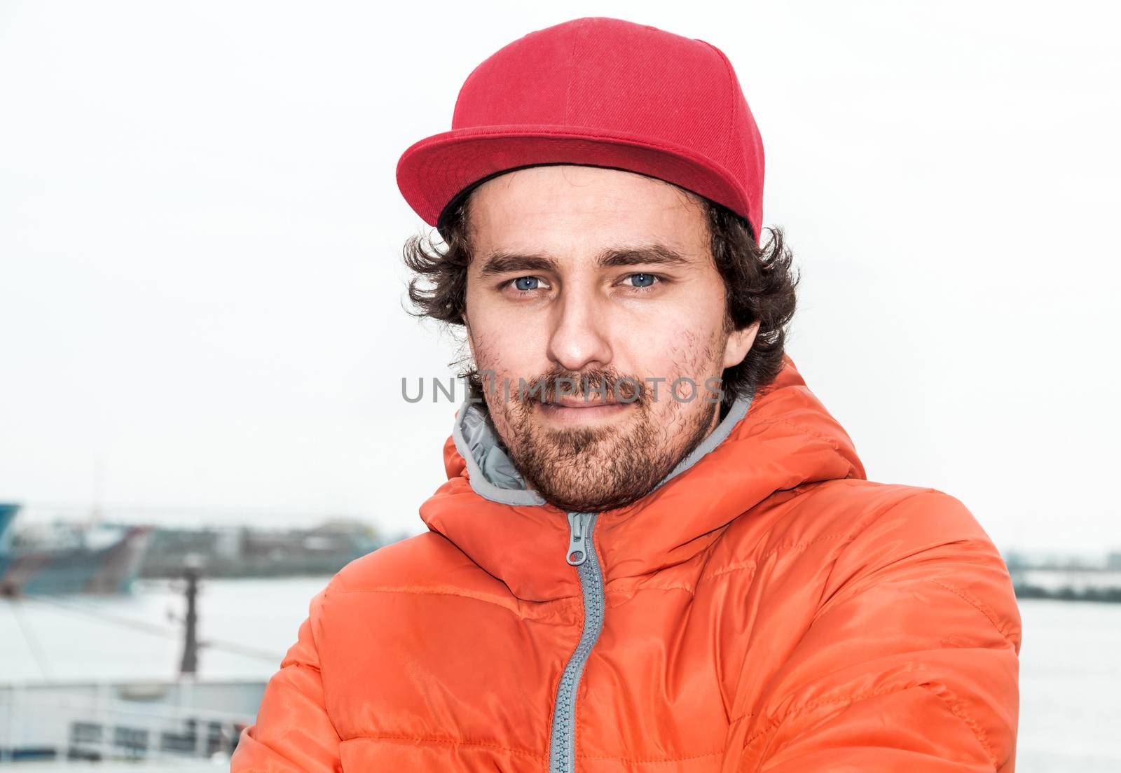 Portrait of a young successful man on the background sea landscape. 